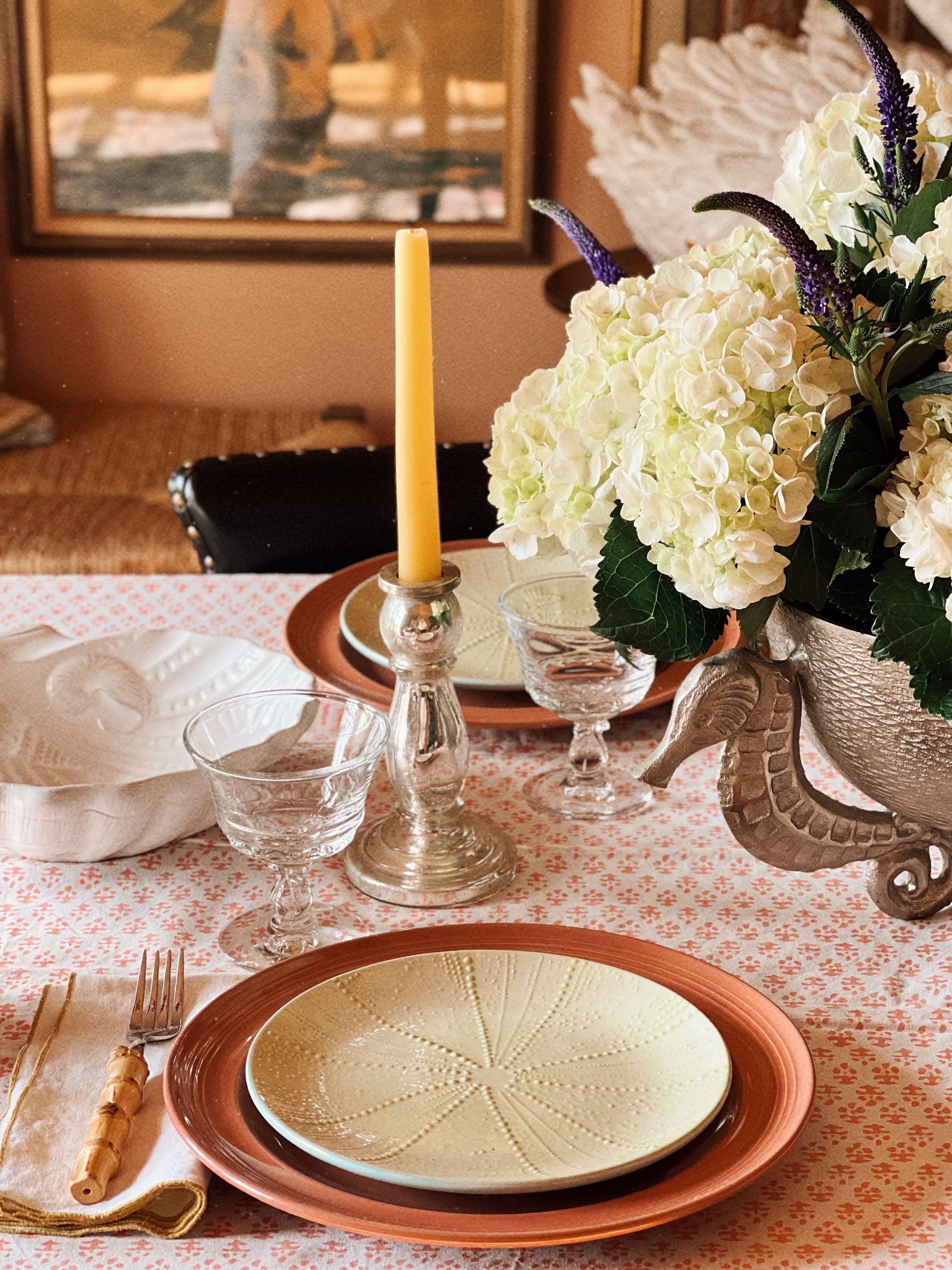 Vintage Fostoria champagne coupes styled on layered coastal table setting with linen and stoneware plates