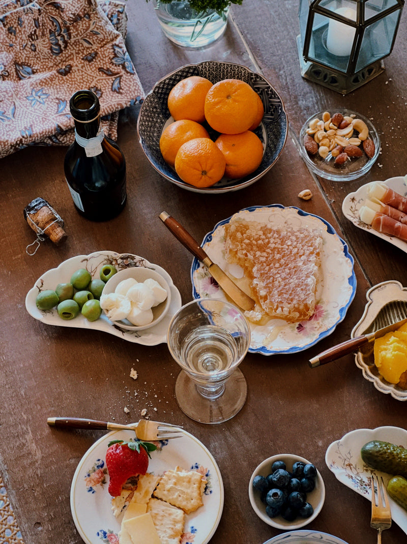 small stoneware bowls used for cheese on a rustic table setting