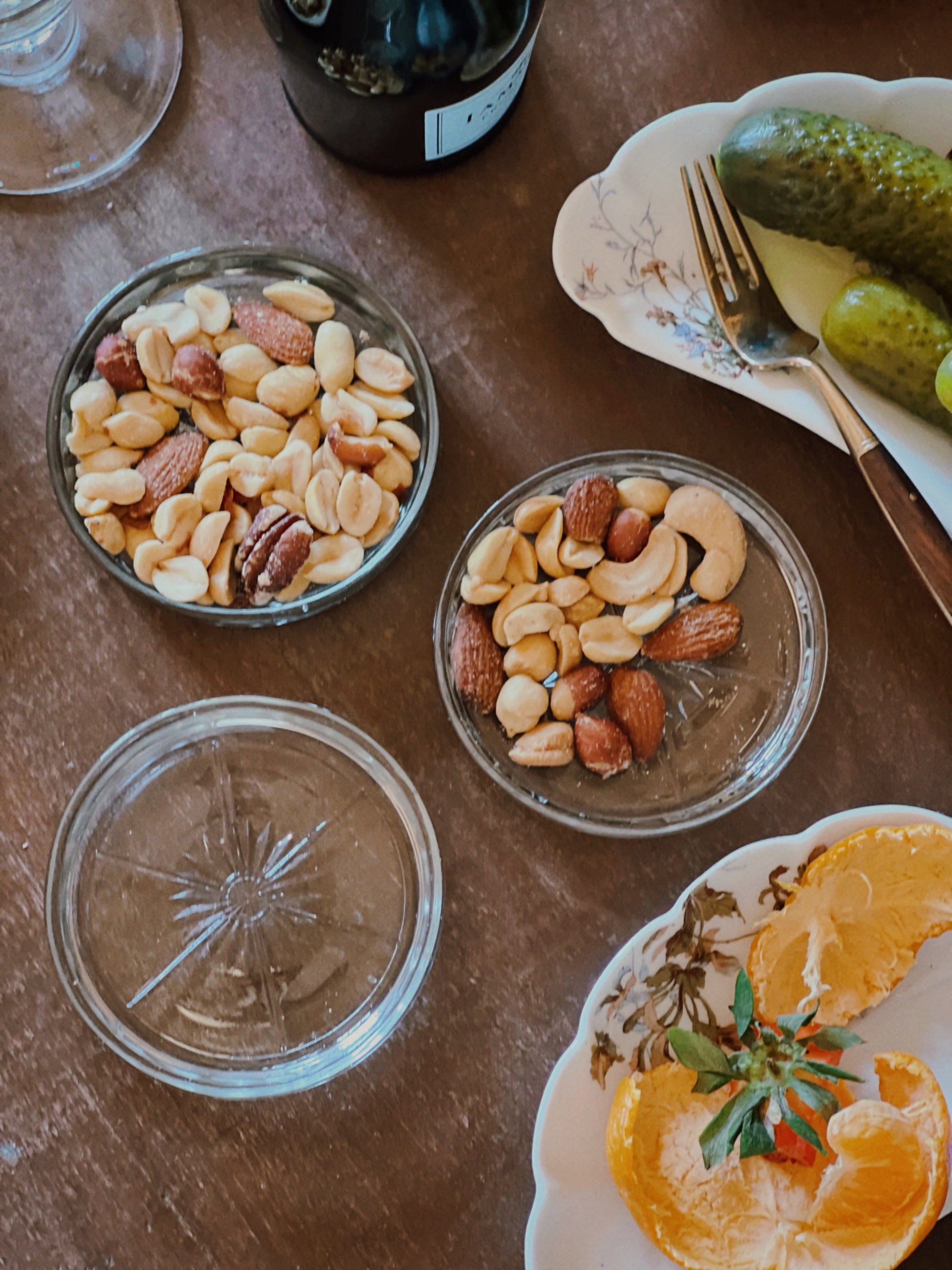 small glass dishes with snacks and olives arranged for casual gathering