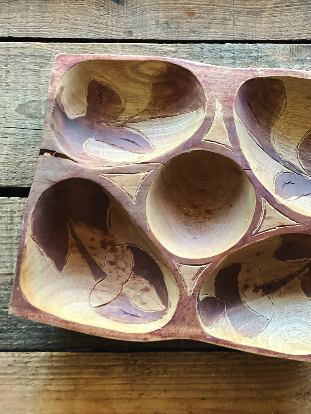 natural split in wood on vintage carved snack dish edge