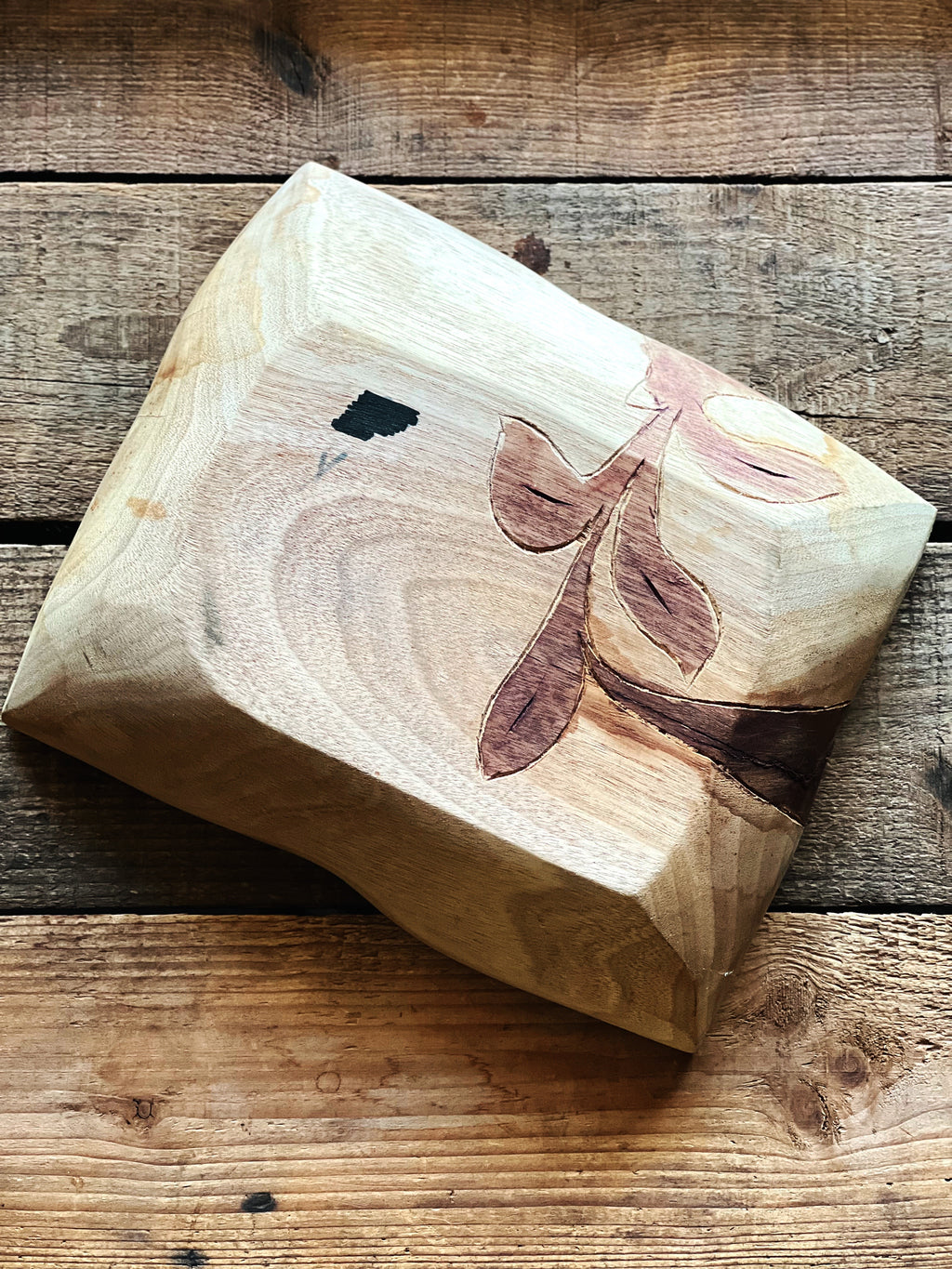 underside of carved wood dish showing construction and finish