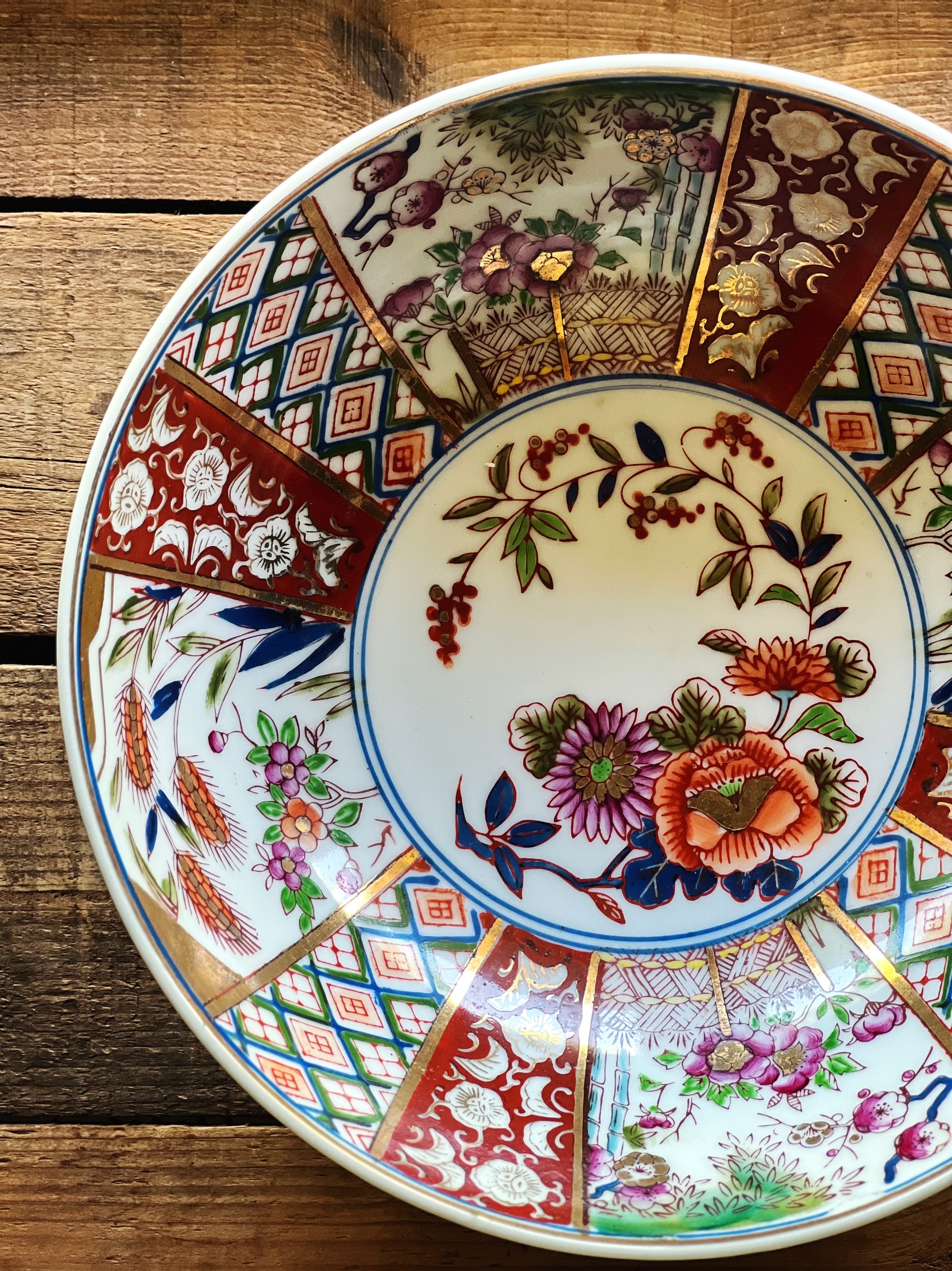 Top view of Japanese porcelain Imari bowl with traditional red blue and floral motifs