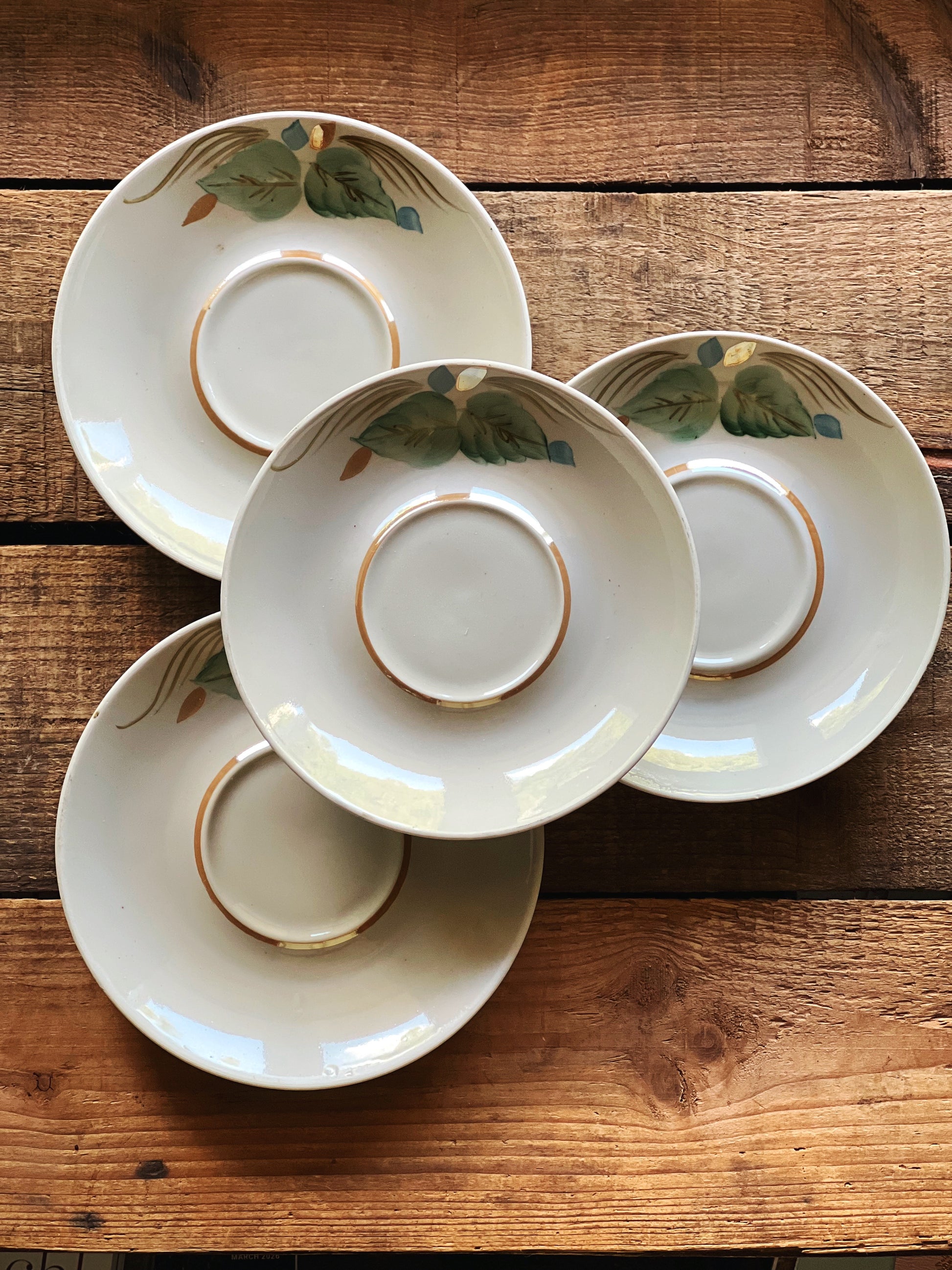 Grouped view of four small vintage saucers showing variation in size