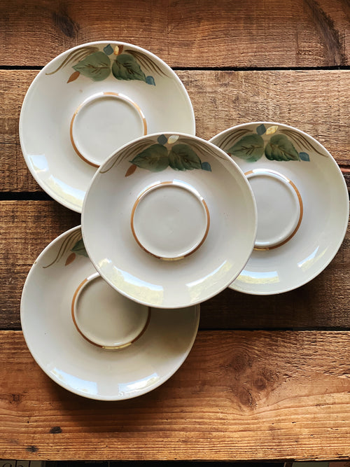 Grouped view of four small vintage saucers showing variation in size