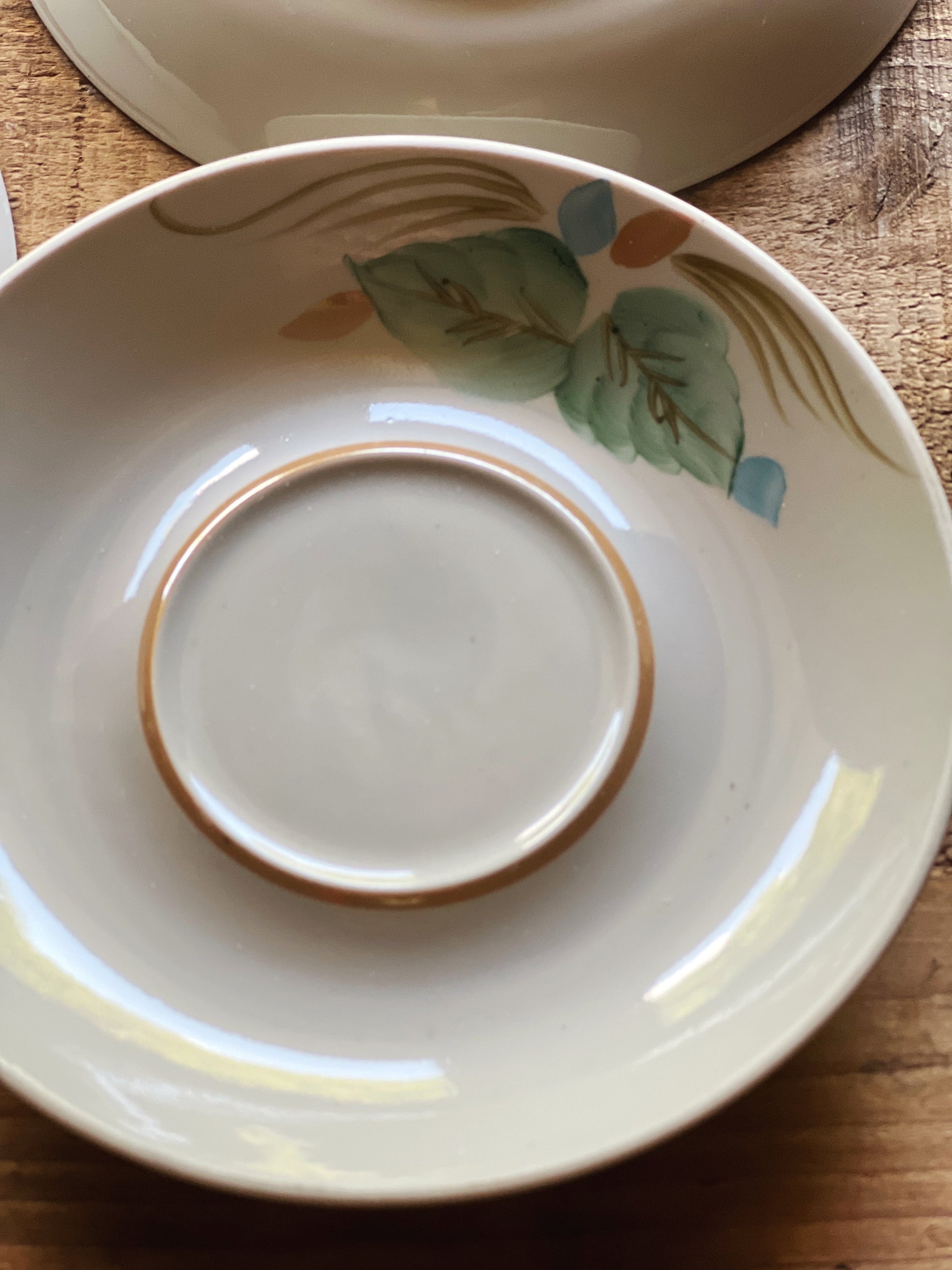 Close up of floral detail on hand painted saucer