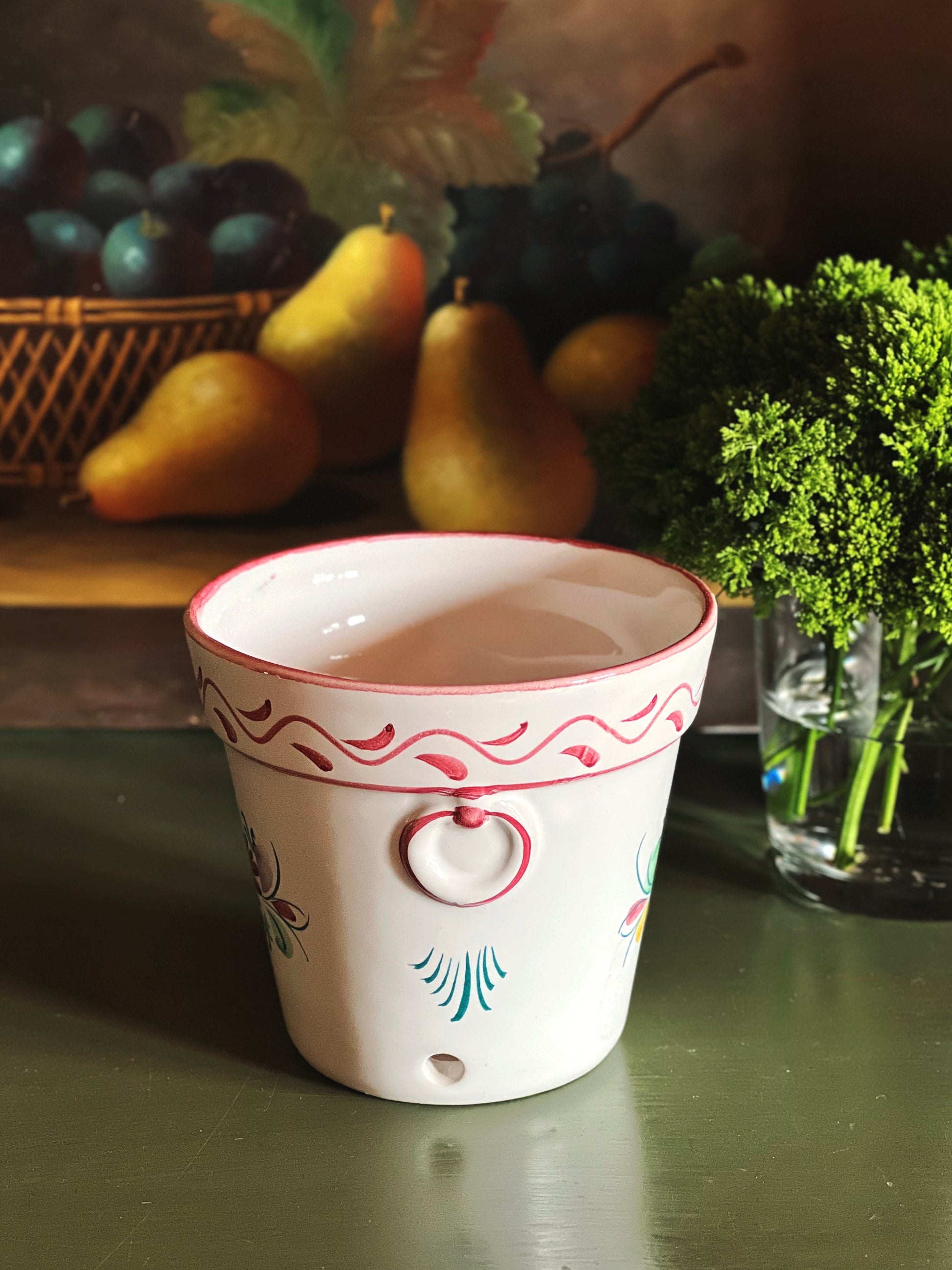 Side view of hand painted cache pot showing detail and shape