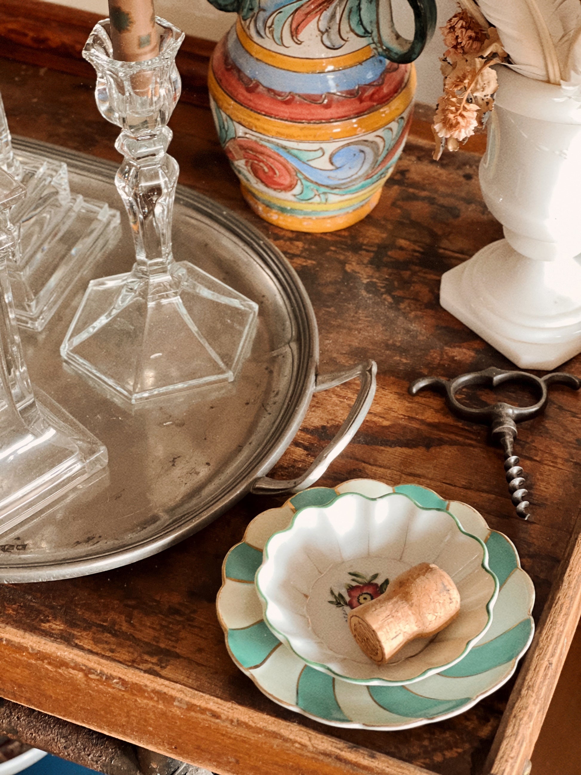 small decorative plates styled on wooden tray with cork