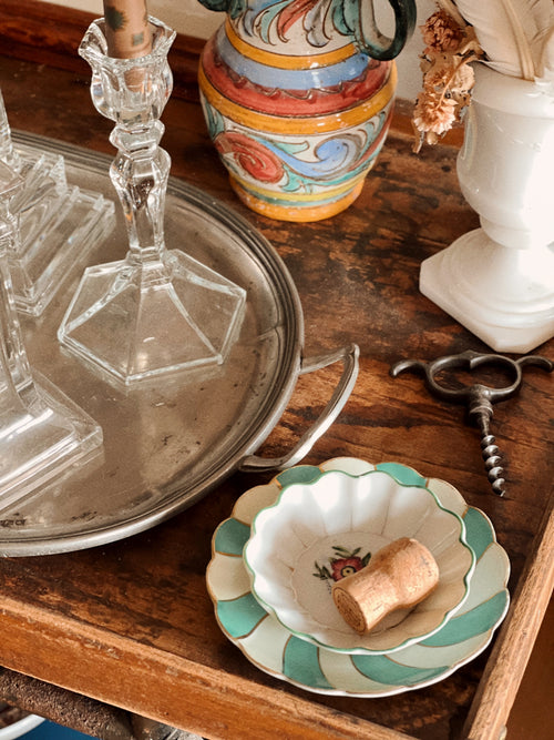 small decorative plates styled on wooden tray with cork