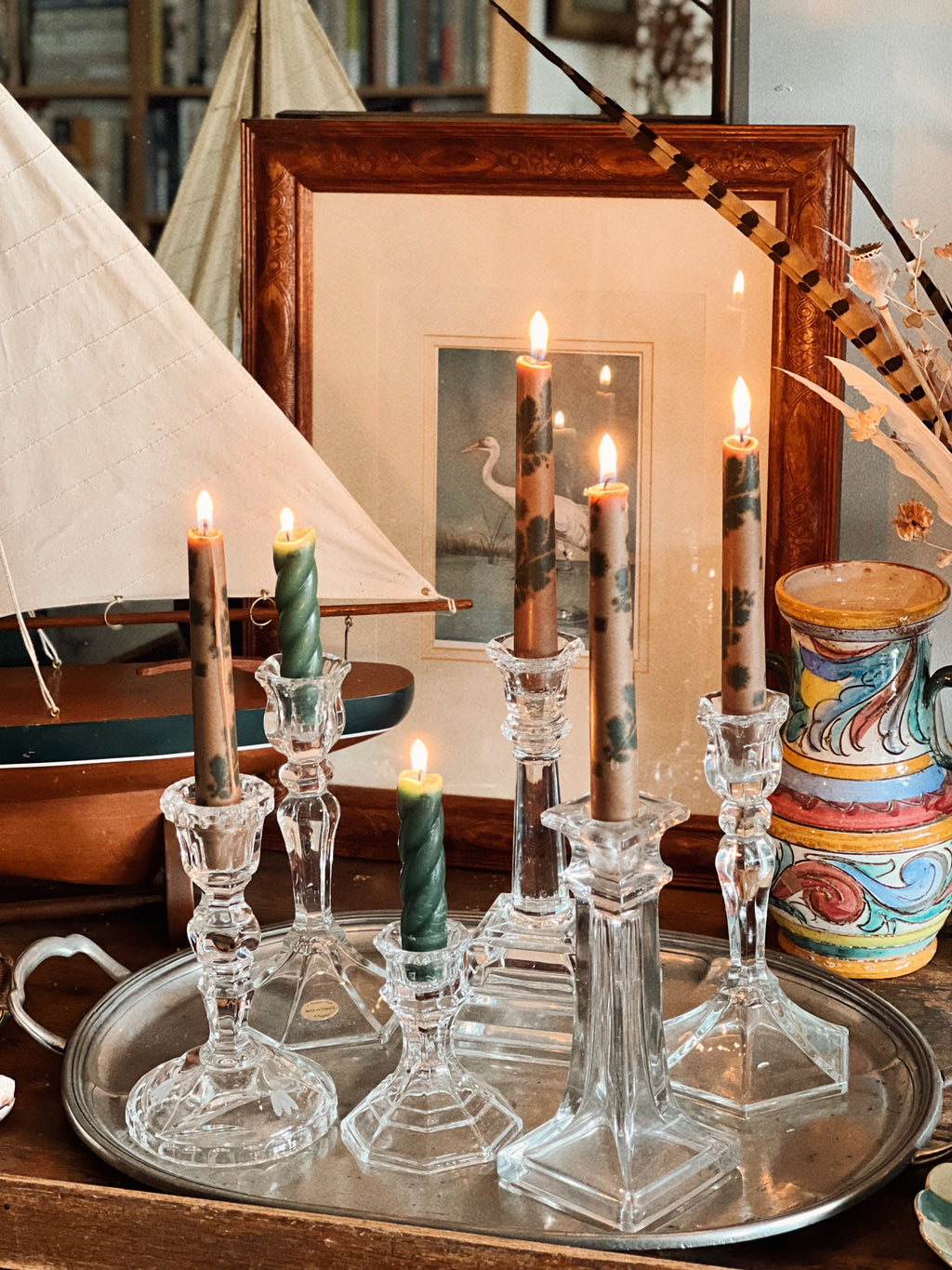 vintage crystal candlesticks arranged on pewter tray with lit candles
