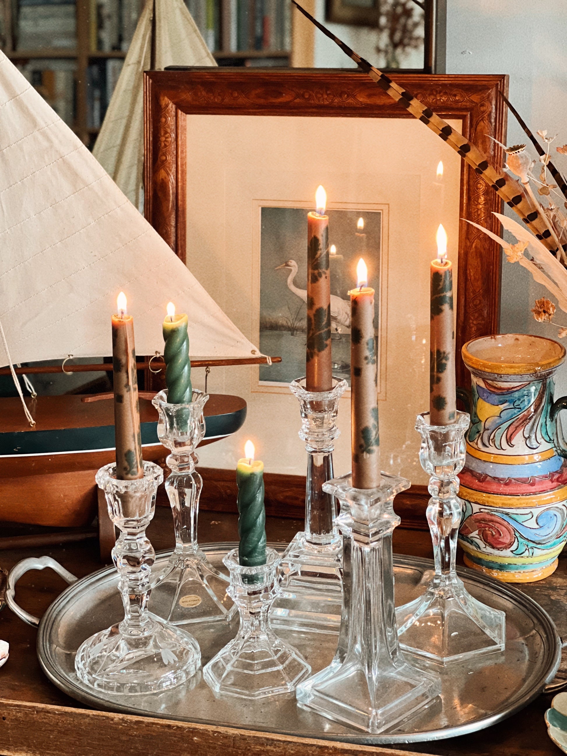 vintage crystal candlesticks arranged on pewter tray with lit candles