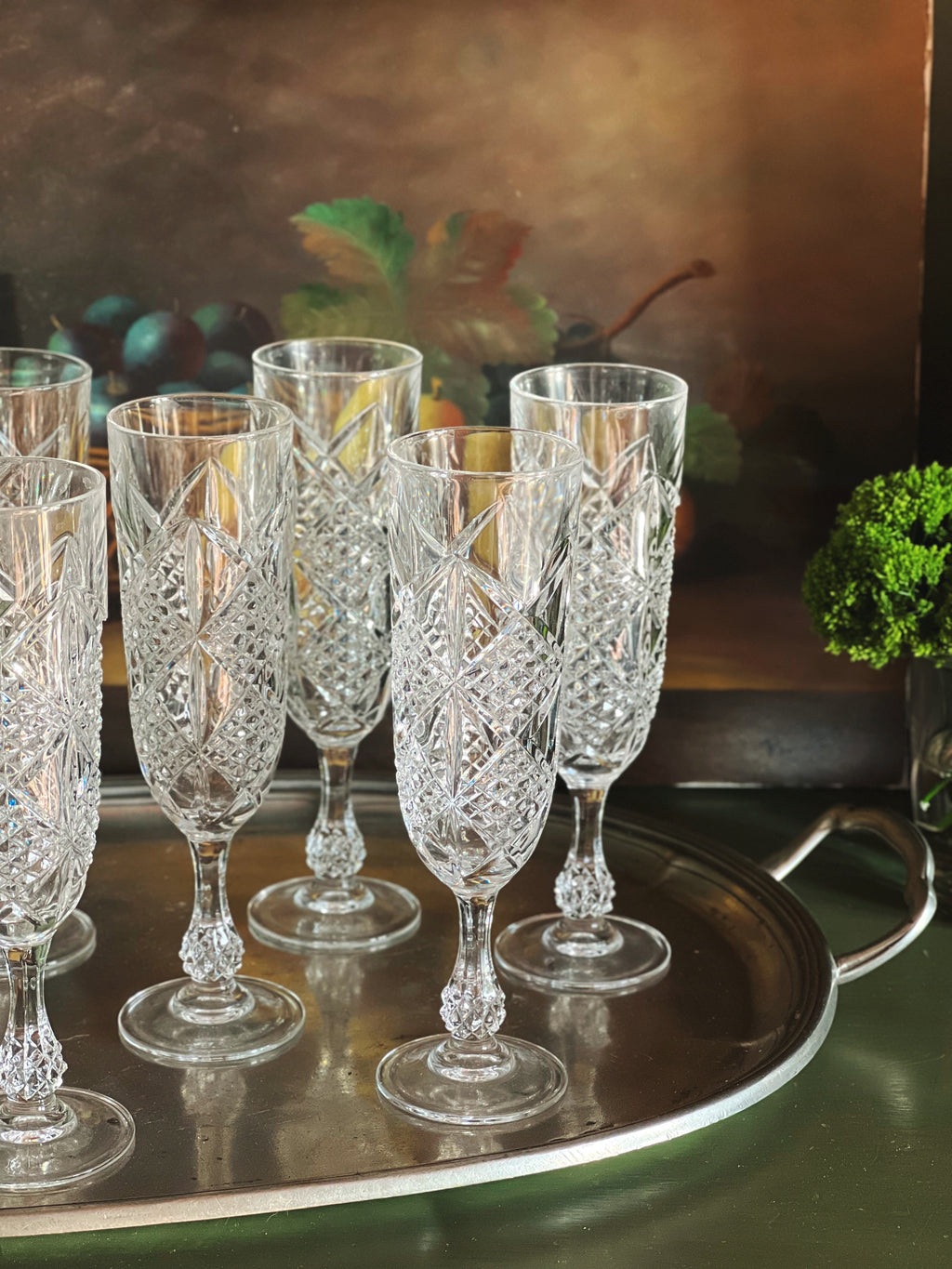 Set of elegant crystal glasses on a reflective surface with a blurred background