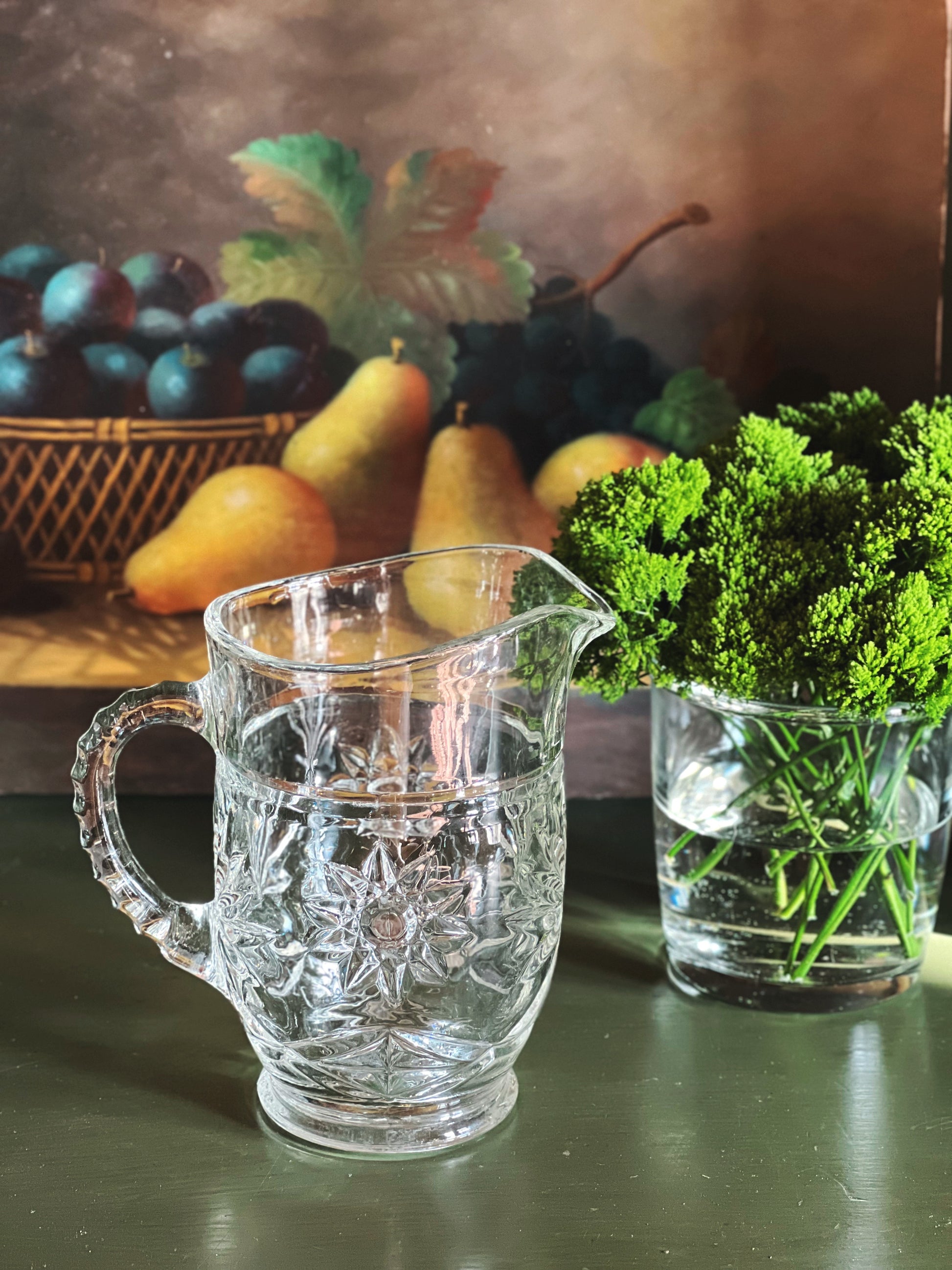 Small vintage cut glass pitcher with detailed handle and pressed starburst design