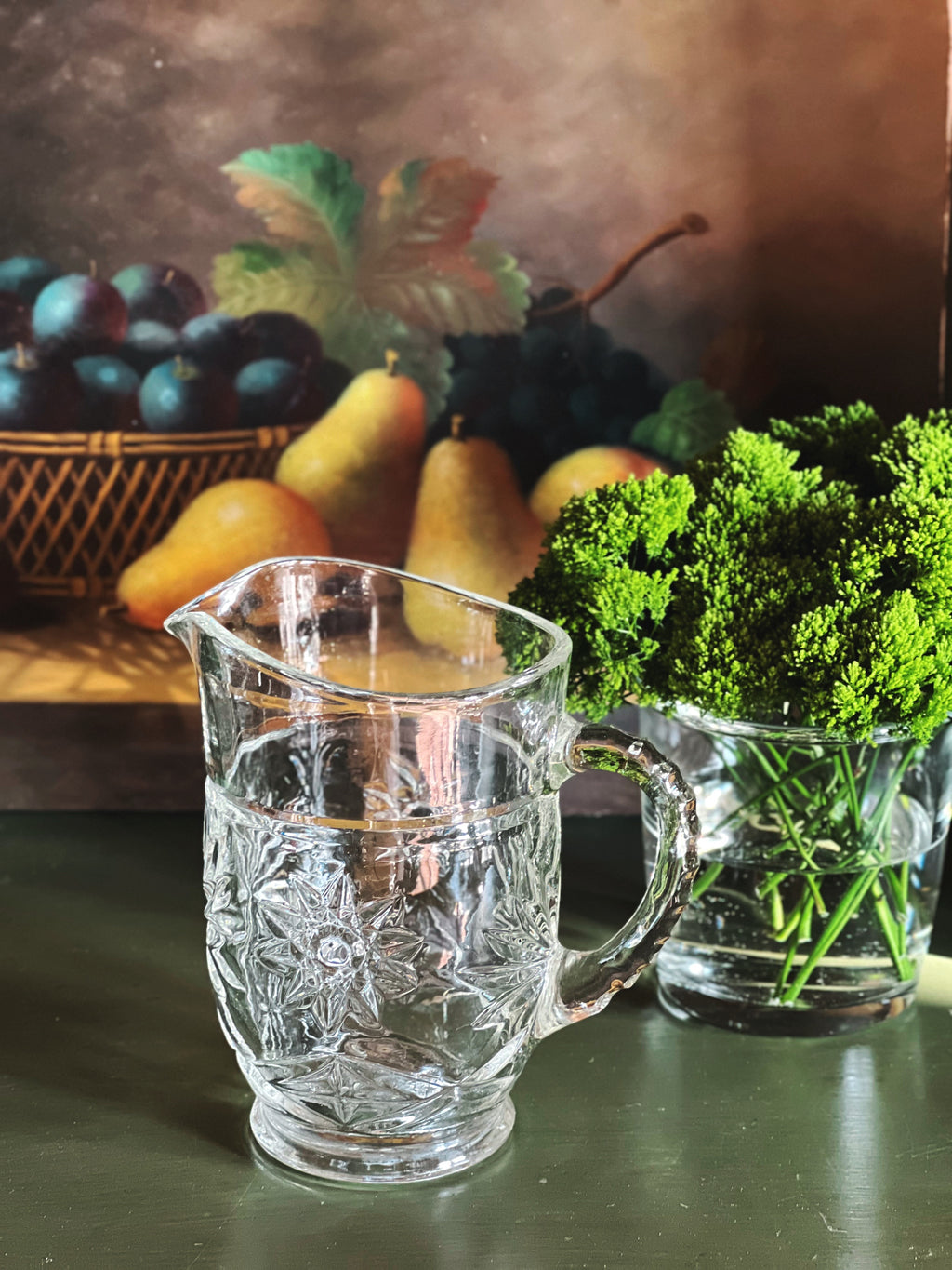 Side angle view of vintage starburst cut glass pitcher