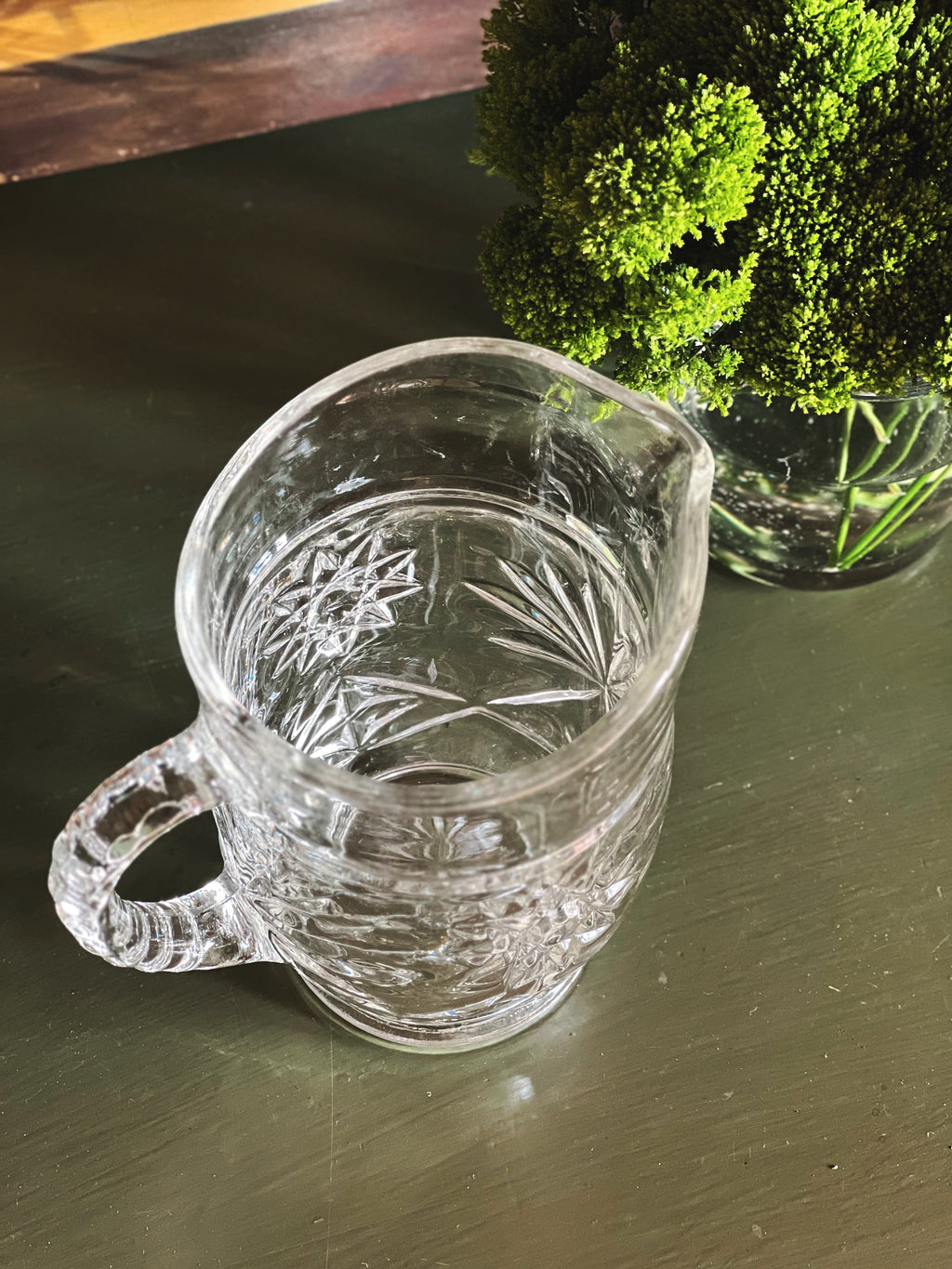 Overhead view of vintage starburst cut glass pitcher