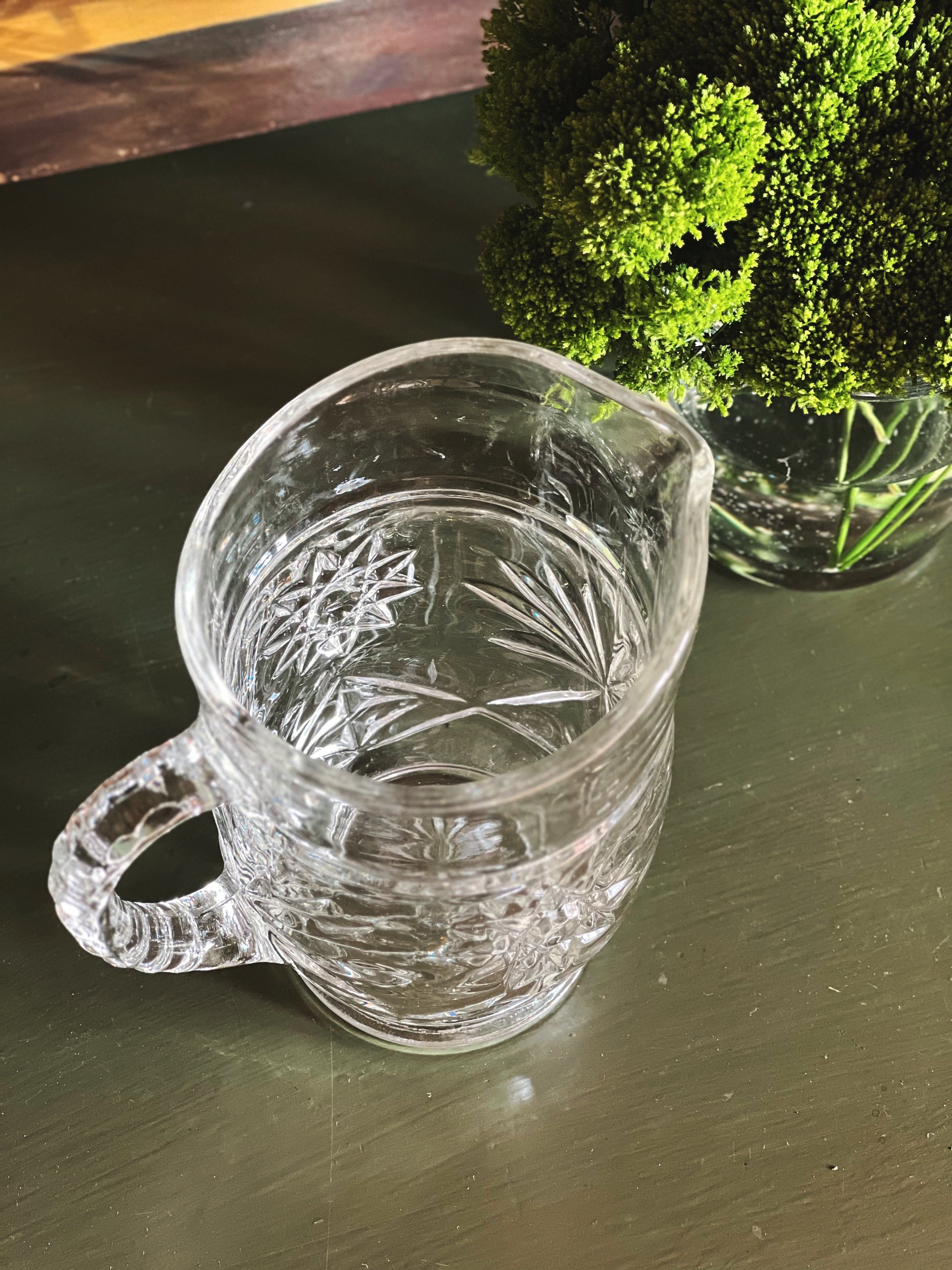 Overhead view of vintage starburst cut glass pitcher