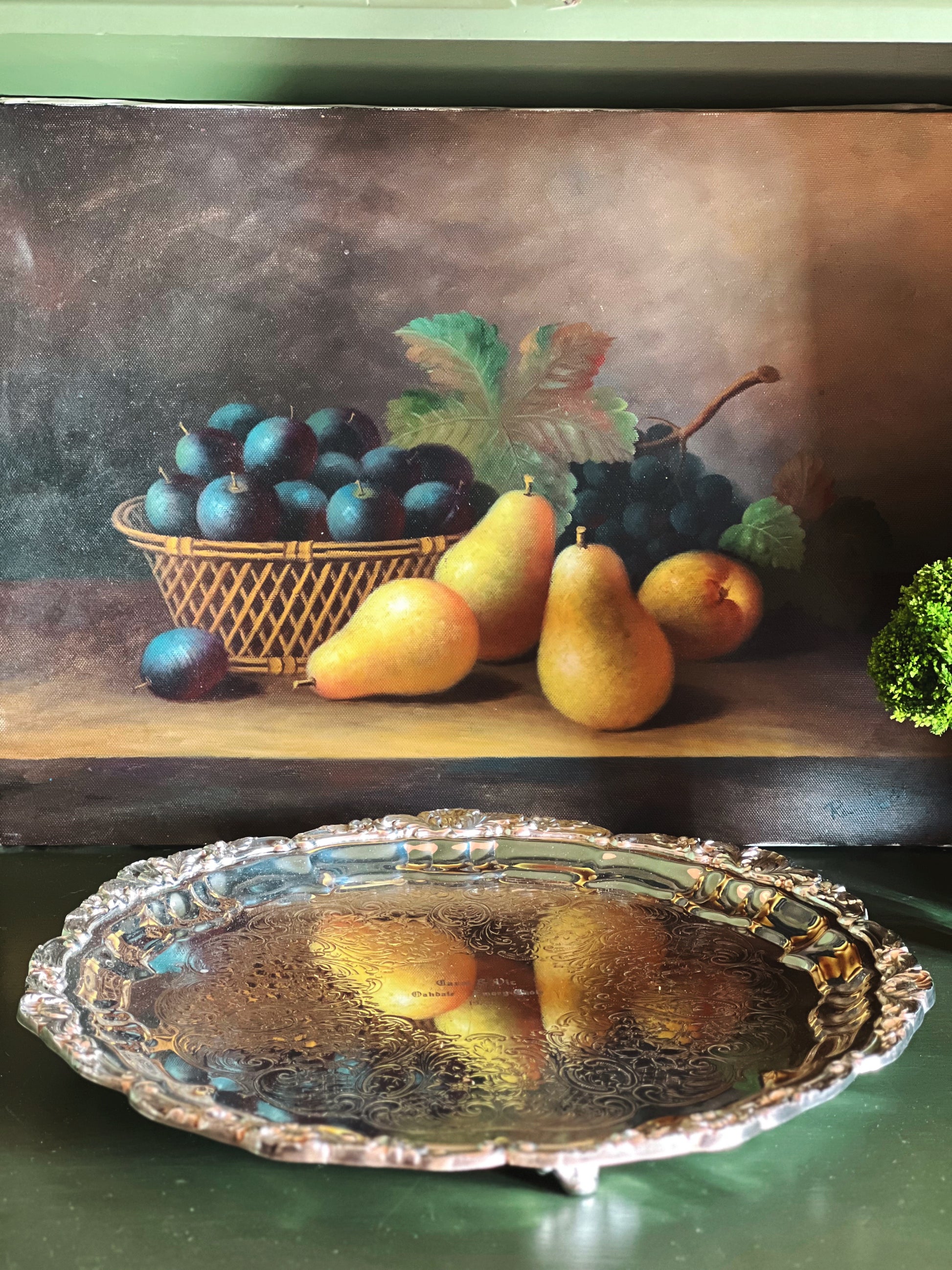 Closeup of engraved silverplate surface showing vintage patina and detail