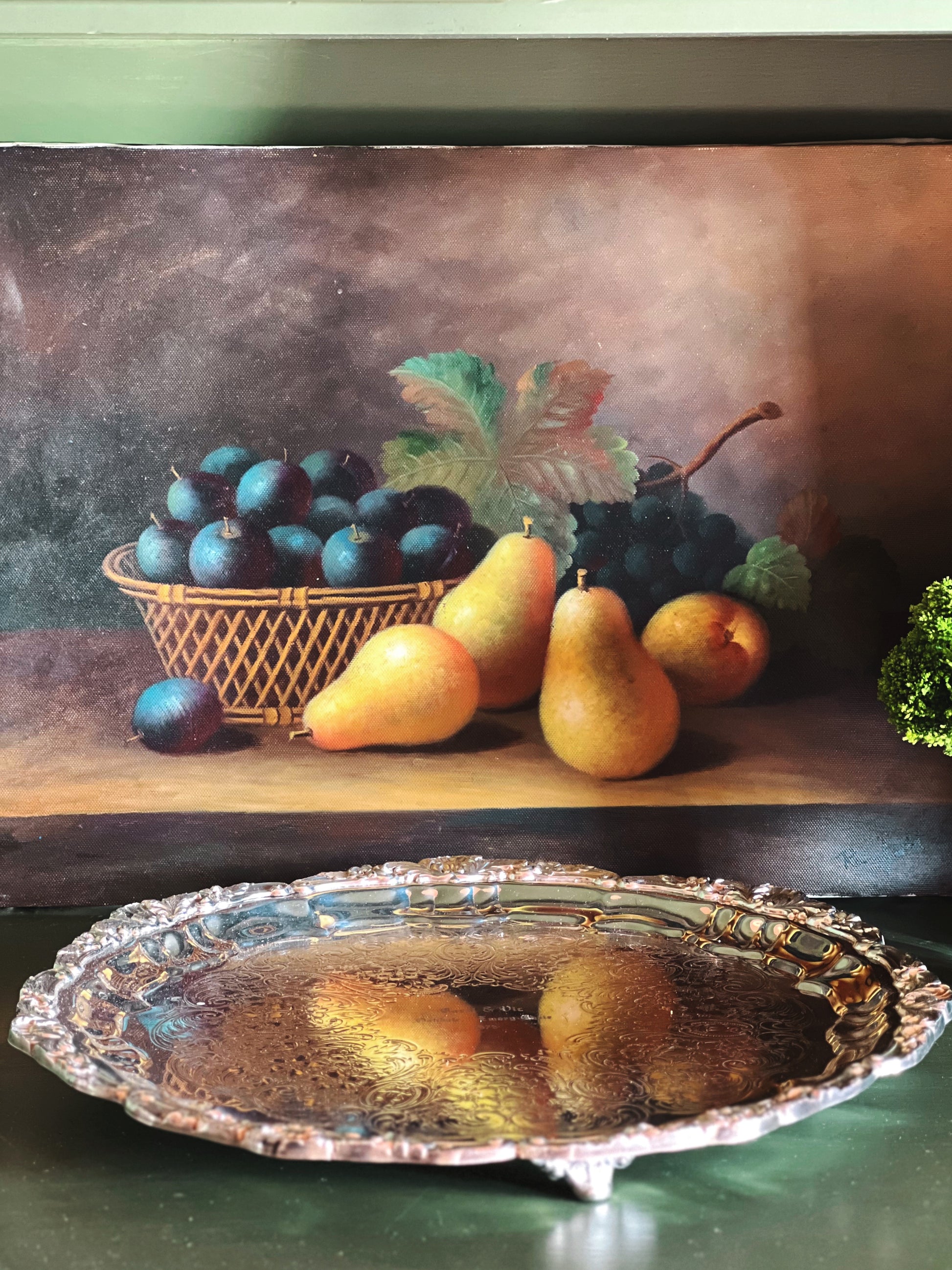 Still life painting of fruits with a silver platter in the foreground