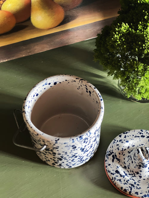 Open vintage spongeware crock showing interior with matching lid beside it