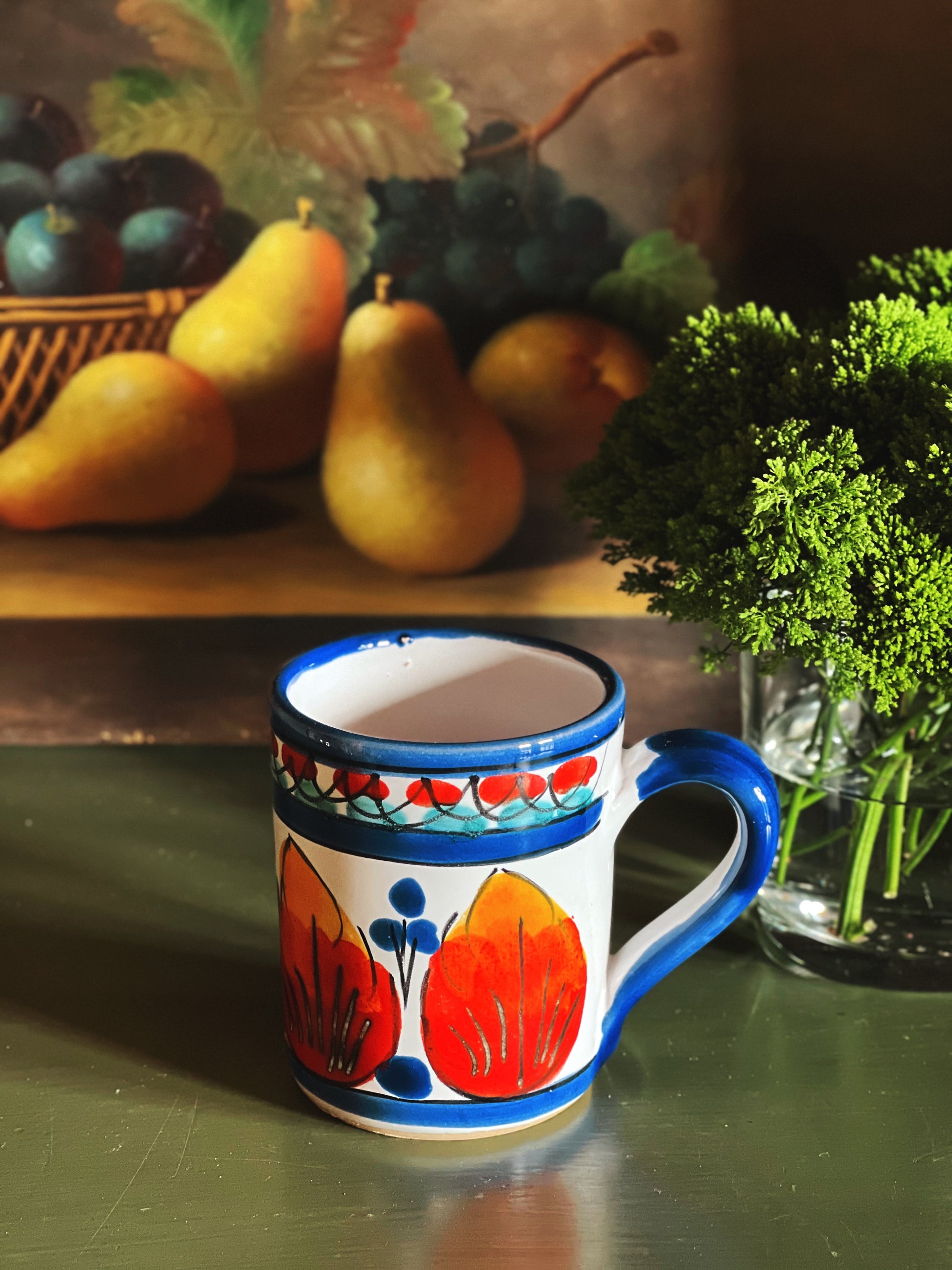 Vintage hand painted ceramic mug with red, blue, and yellow pattern