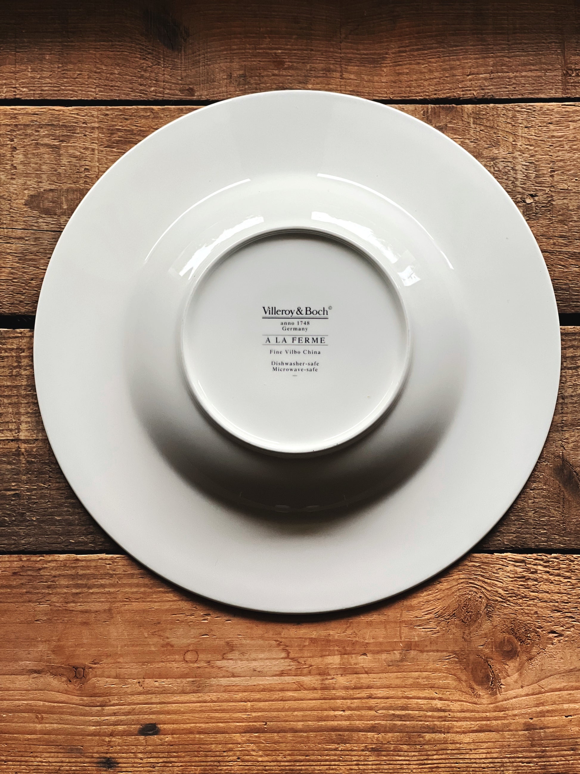 White bowl with 'Villeroy & Boch' branding on a wooden surface