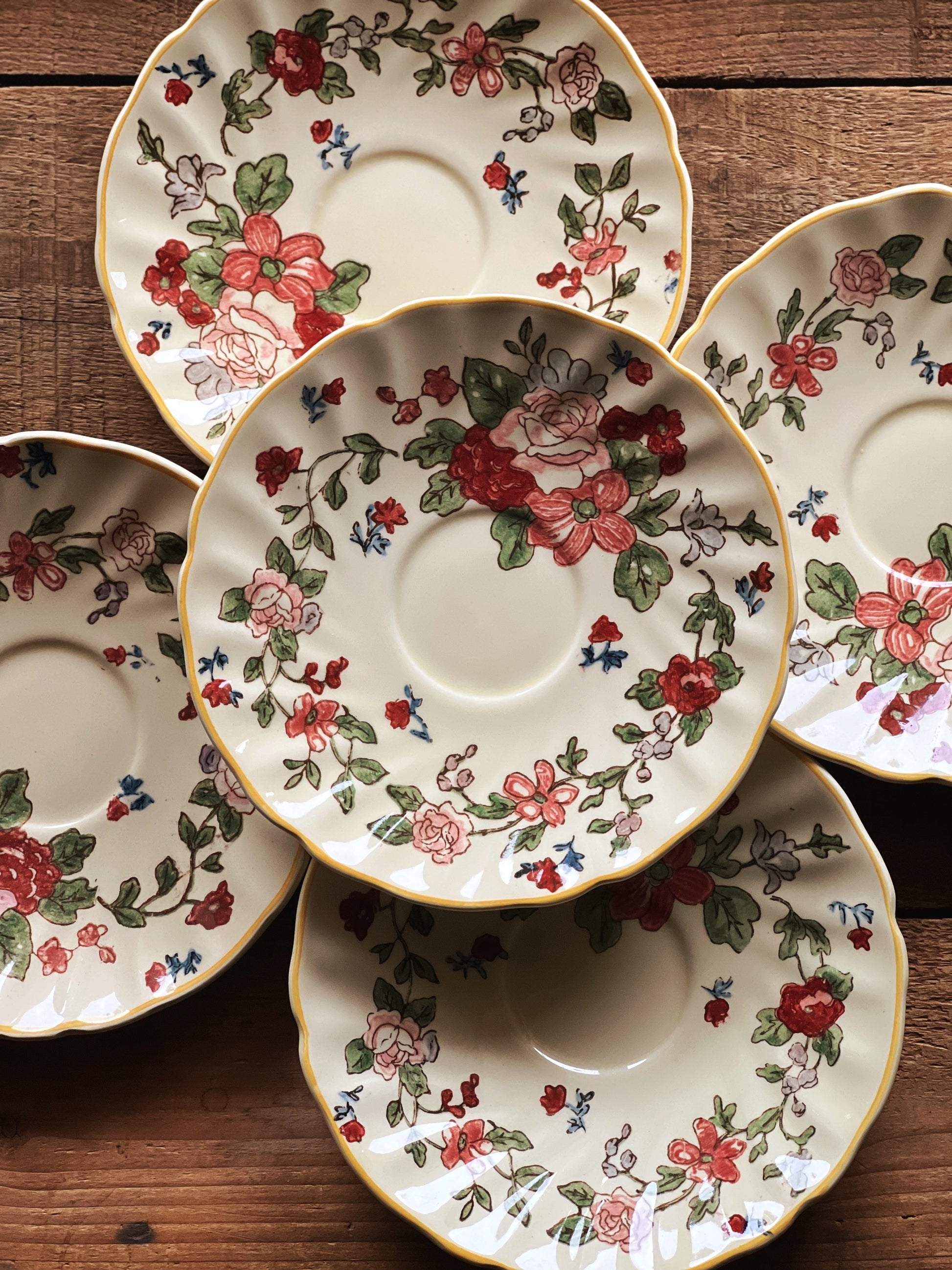 Vintage ROYAL DOULTON Wildflowers saucers arranged on rustic wood surface with floral English china pattern