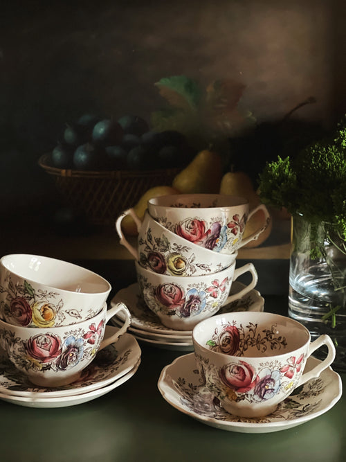 Stacked vintage JOHNSON BROTHERS Sheraton teacups and saucers with floral English ironstone pattern