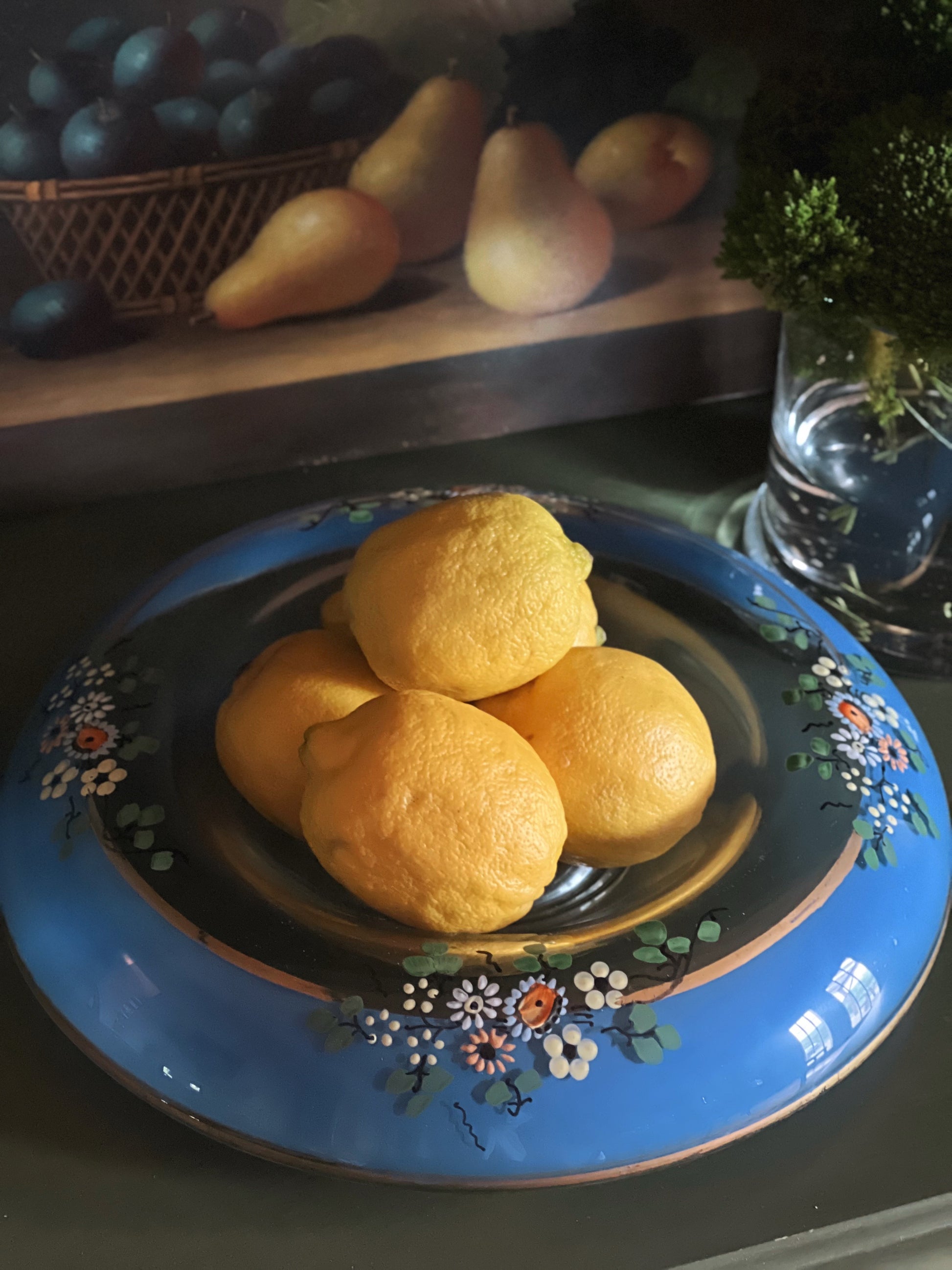 decorative glass bowl with floral design filled with fresh lemons