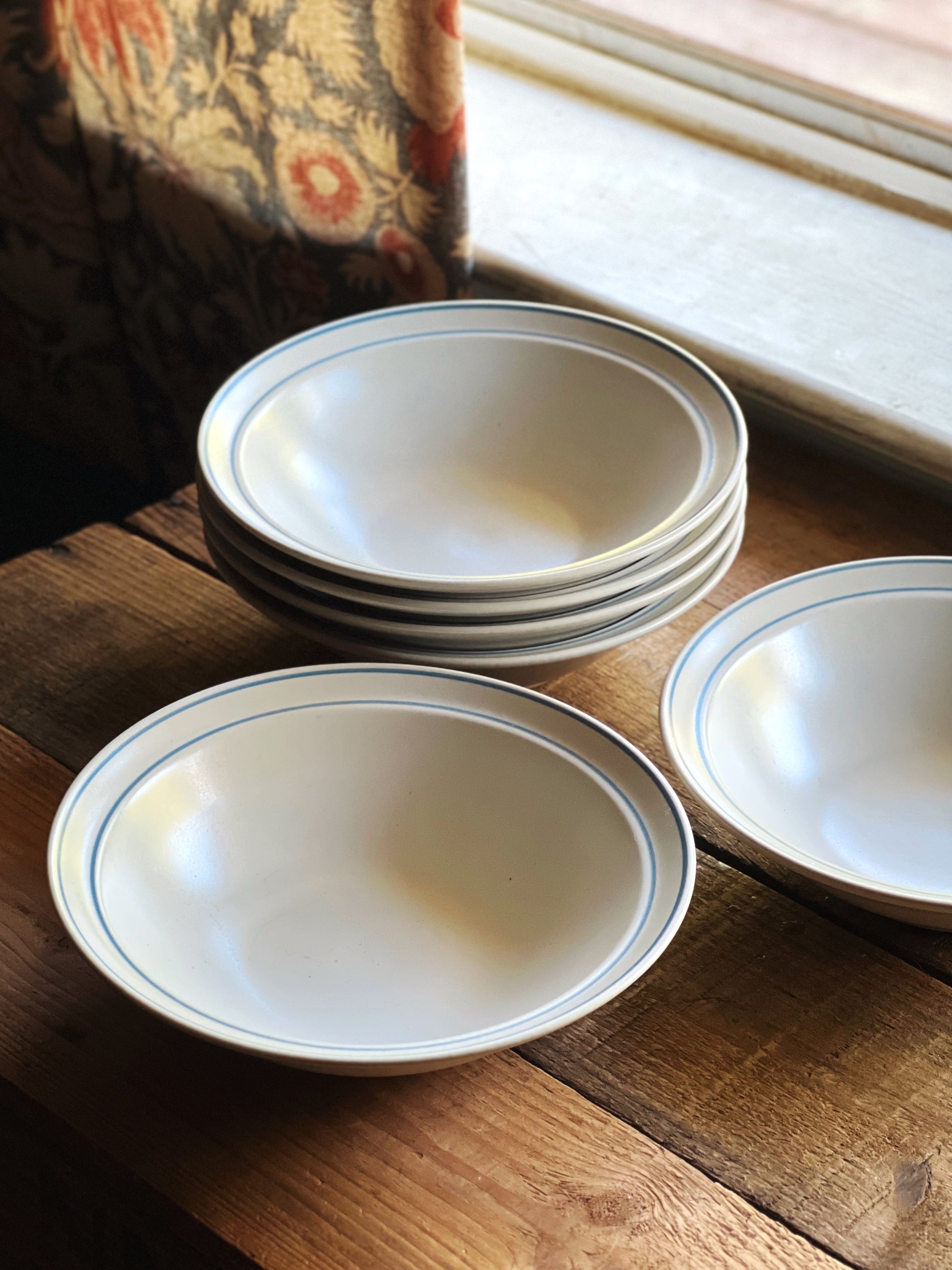 Stacked Blue Leaf Japan cereal bowls on a wood table