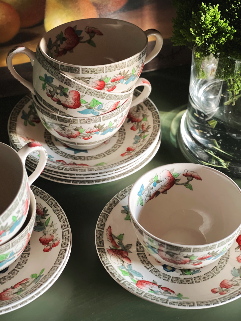 Stacked floral teacups styled on collected cottage breakfast table