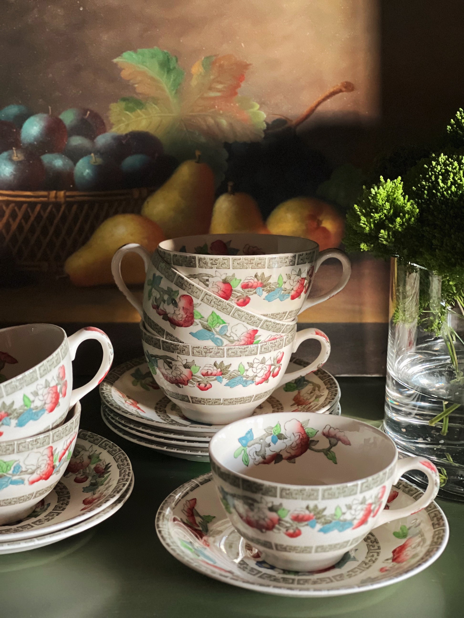 stacked Johnson Brothers Indian Tree teacup and saucer sets