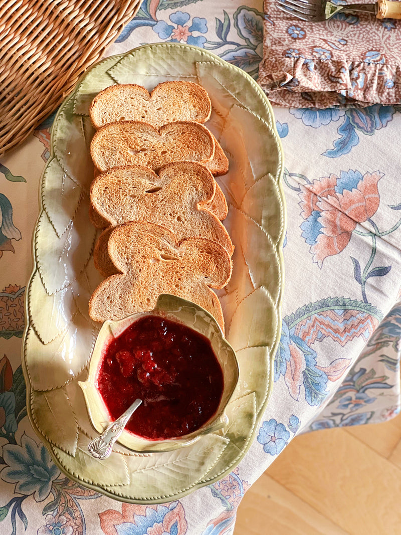 Italian ceramic leaf platter with bread slices and jam styled for cottage breakfast entertaining