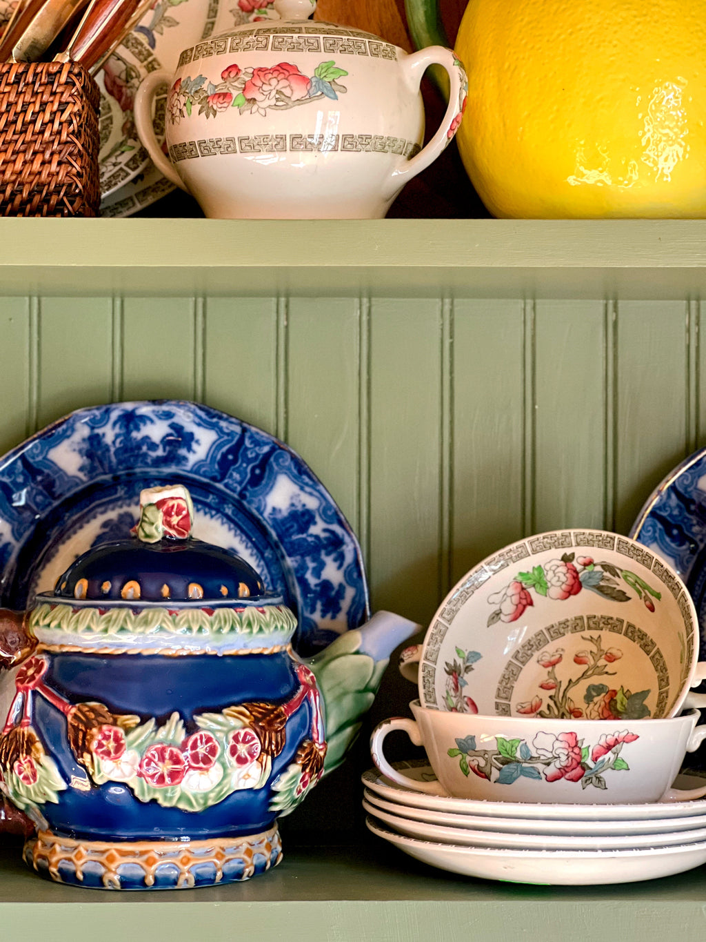 Collected vintage cottage kitchen shelf with navy teapot and English transferware