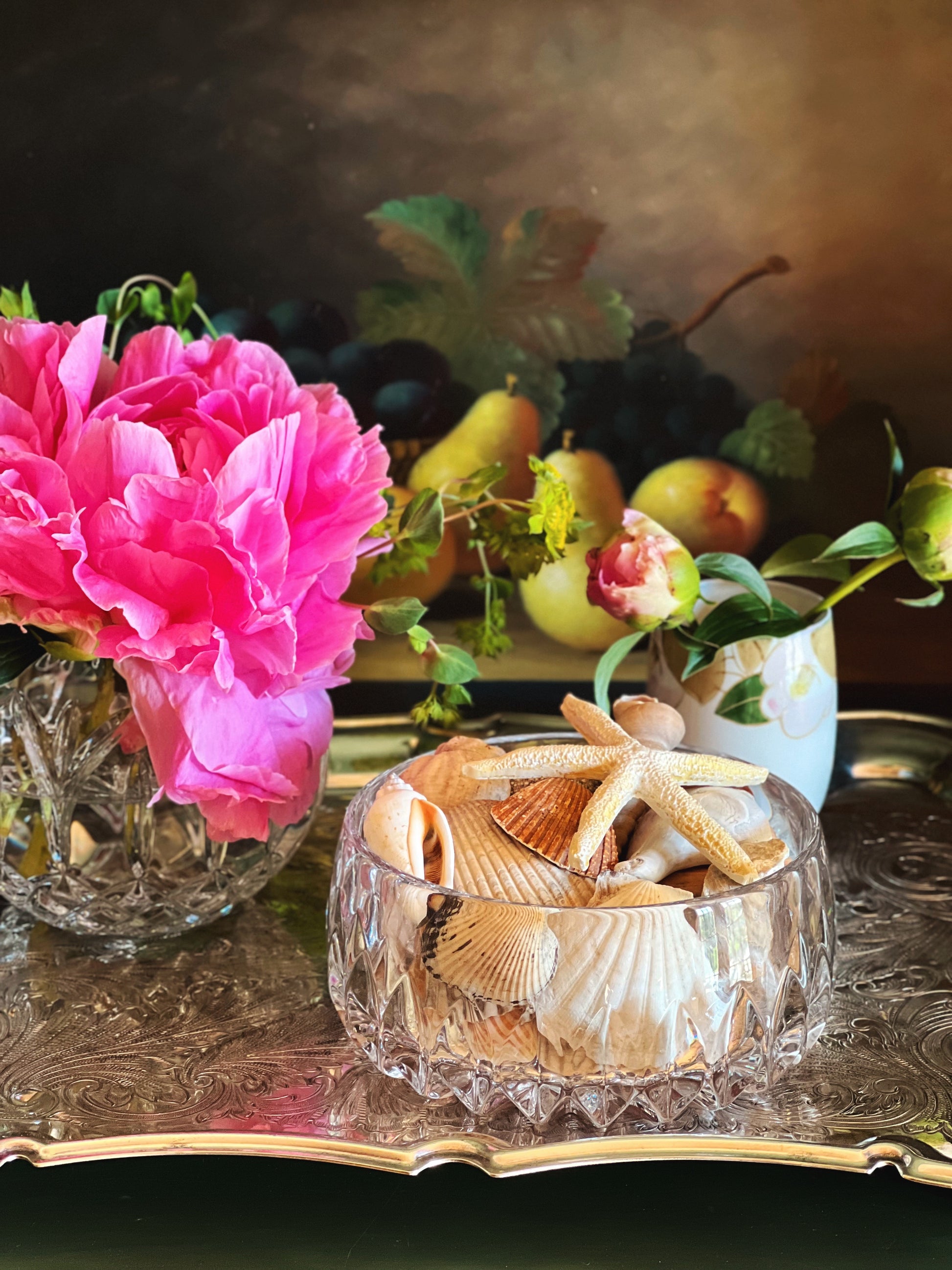 Front view of a crystal bowl on a silver tray with floral arrangements