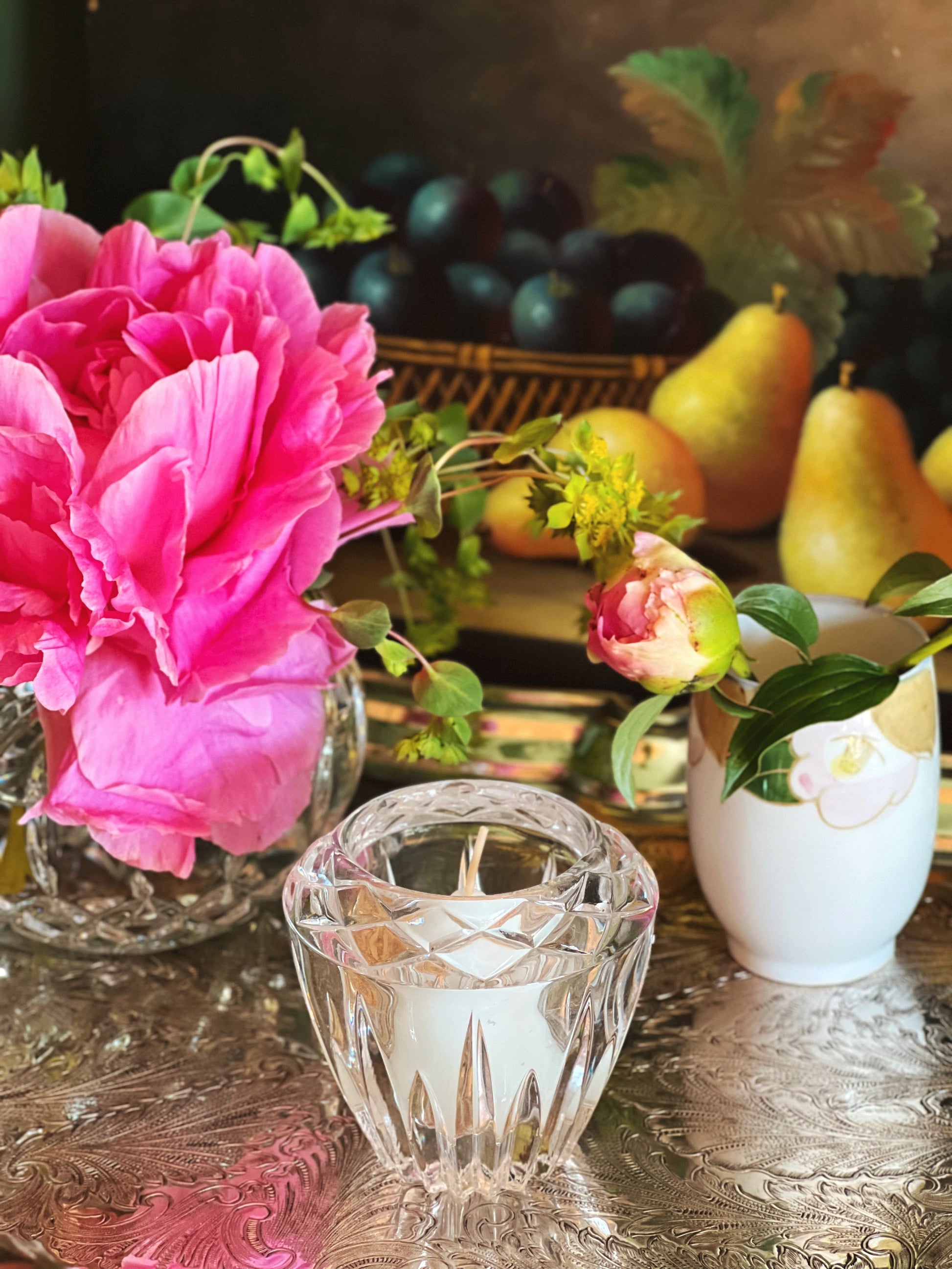 Vintage crystal candleholder styled with peonies and collected tabletop decor