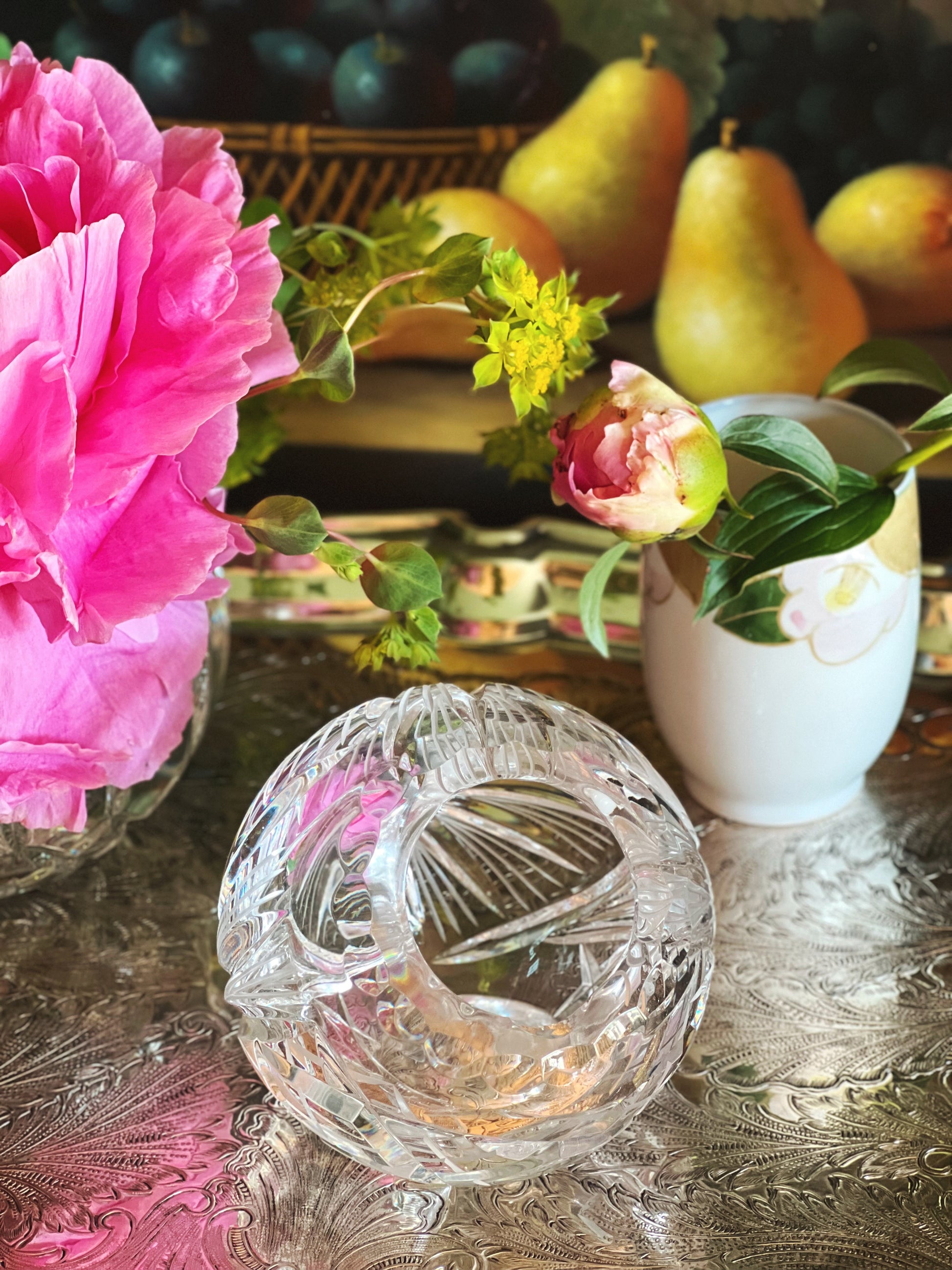 Crystal angled bowl on a silver tray with floral arrangements