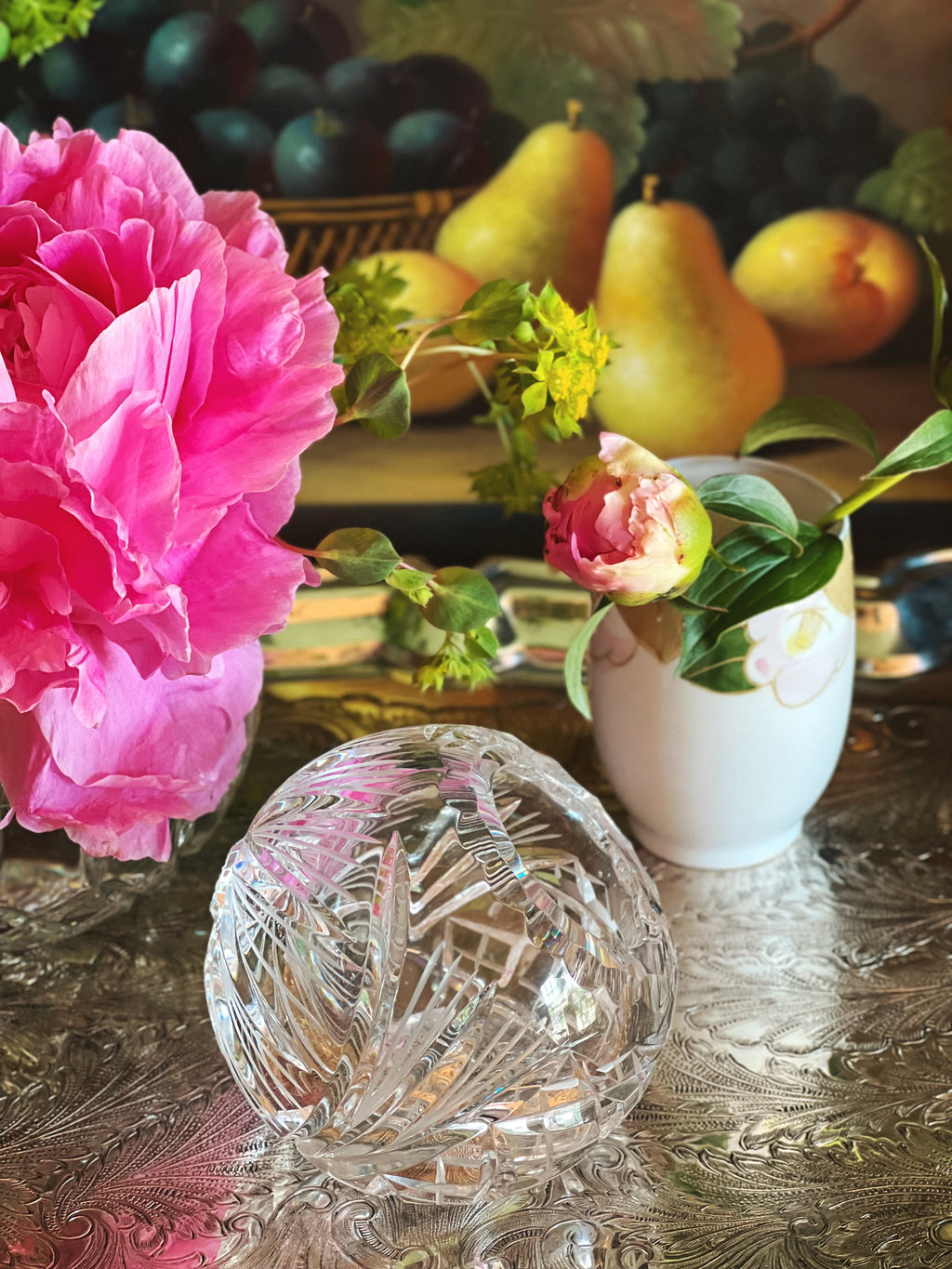 side view of a cut crystal angled vase next to flowers