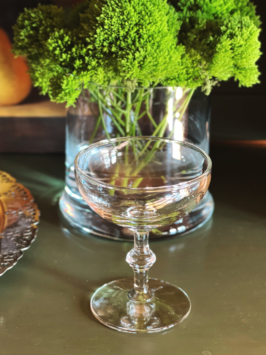 Single vintage champagne coupe close up showing detail of bamboo stem