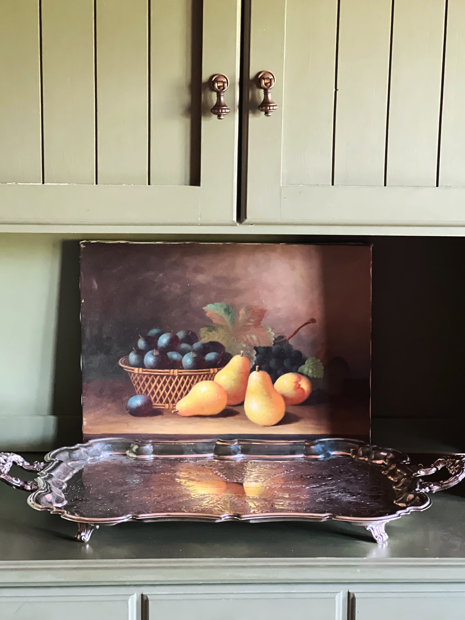 Full front view of a large vintage Leonard silverplate butler’s tray with ornate engraved surface