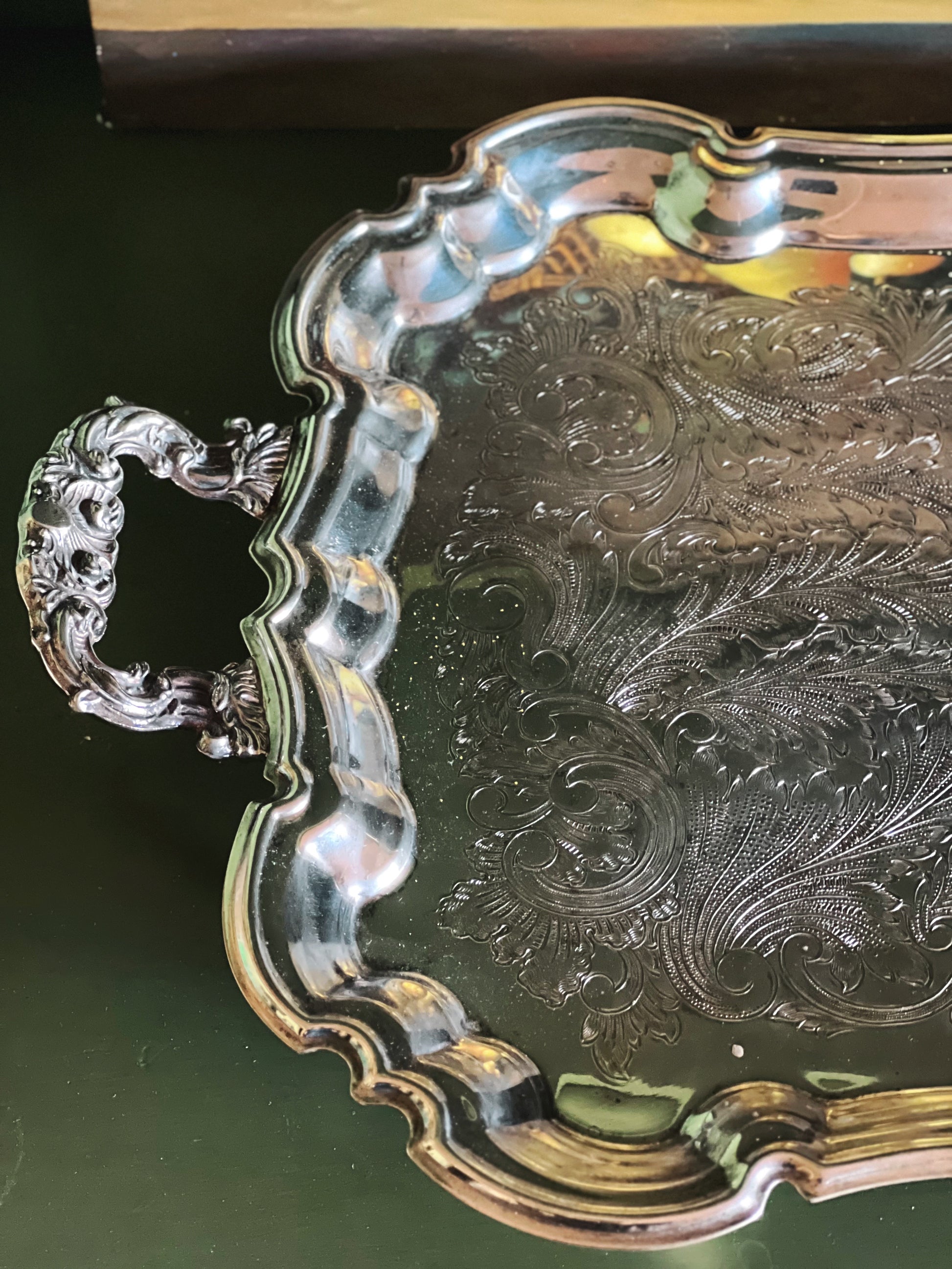 Handle and edge detail of a large vintage Leonard silverplate butler’s tray