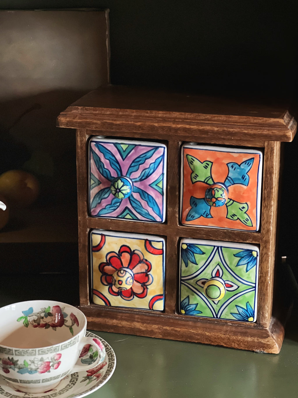 Decorative wooden box with colorful ceramic tiles on a table