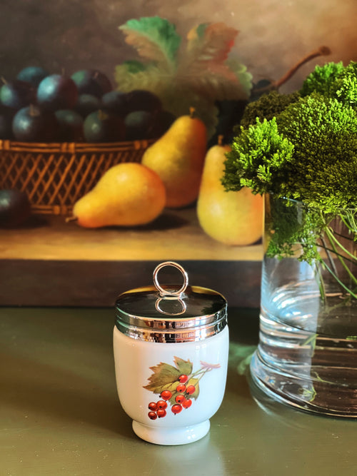 Royal Worcester Evesham Gold egg coddler on green tabletop