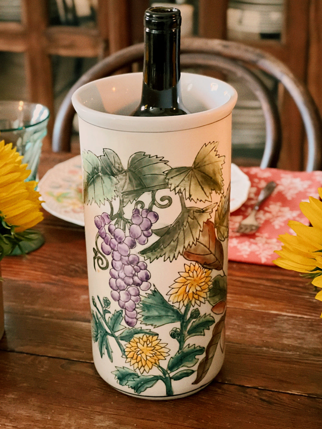 Decorative wine cooler with floral design on a wooden table