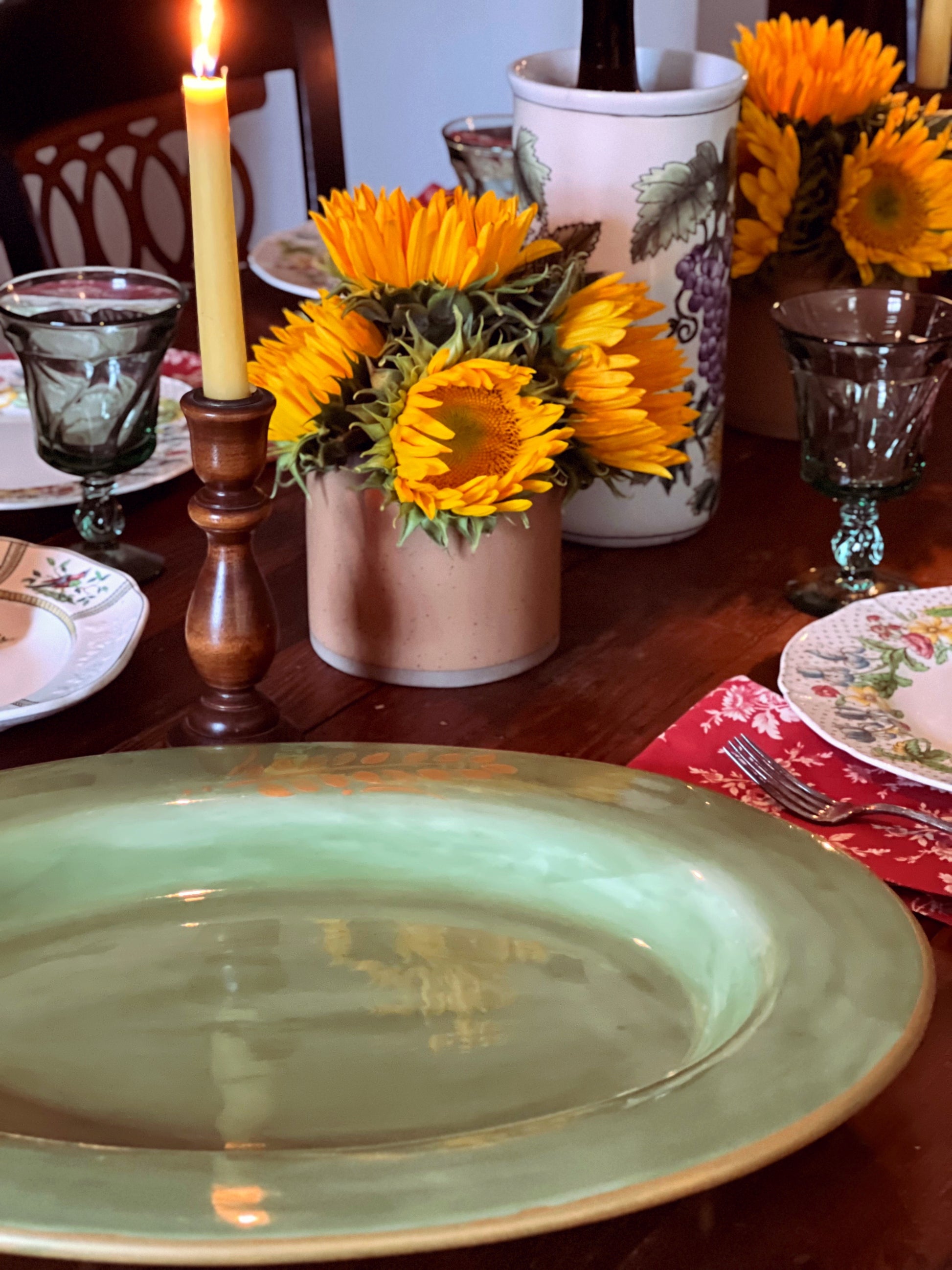 Side view of a Pottery Barn Sausalito serving platter on a table with candlelight and sunflowers