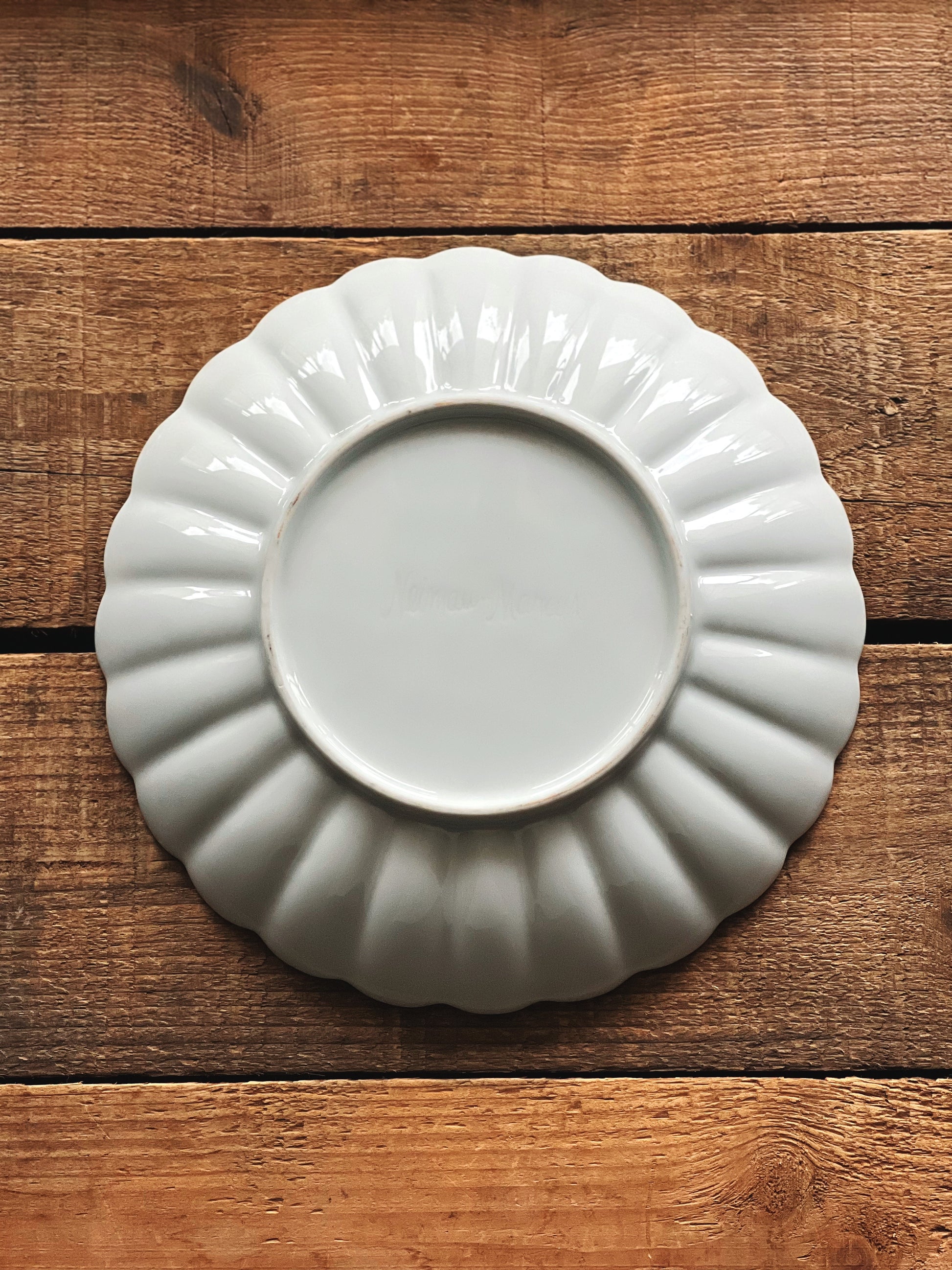 Back view of Neiman Marcus scalloped ceramic plate