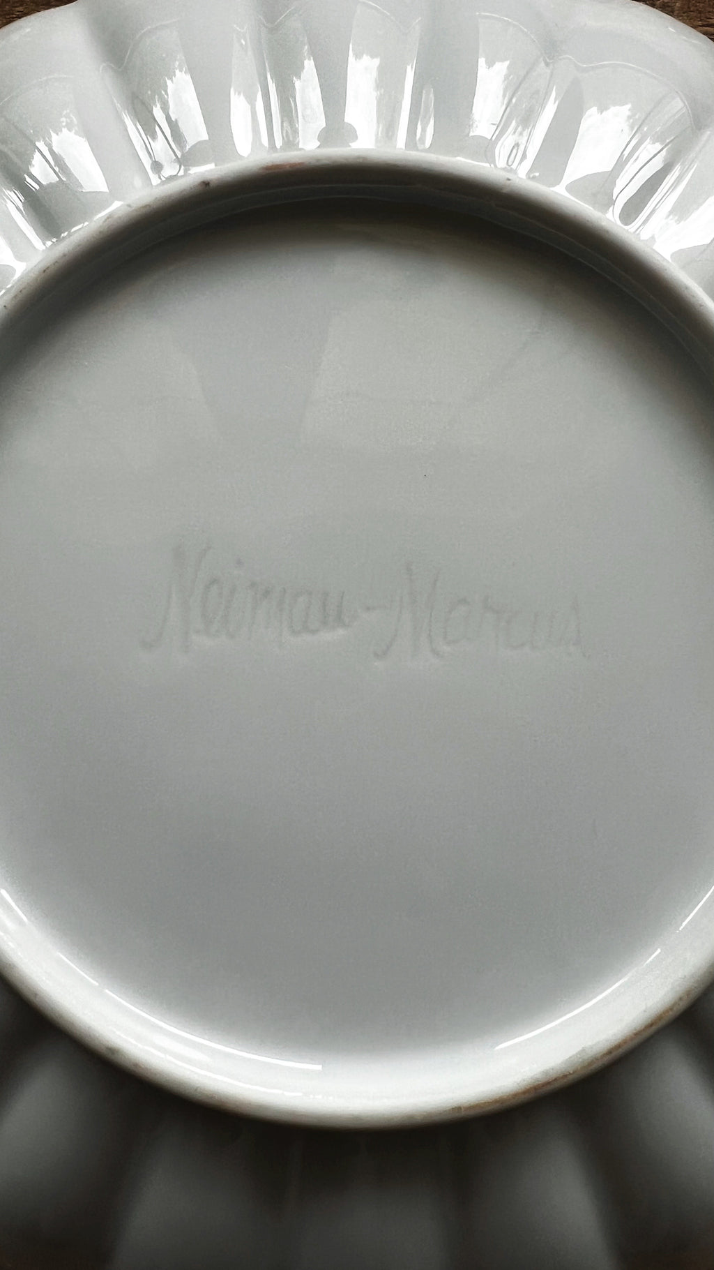 Close-up of fluted edge on white ceramic salad plate