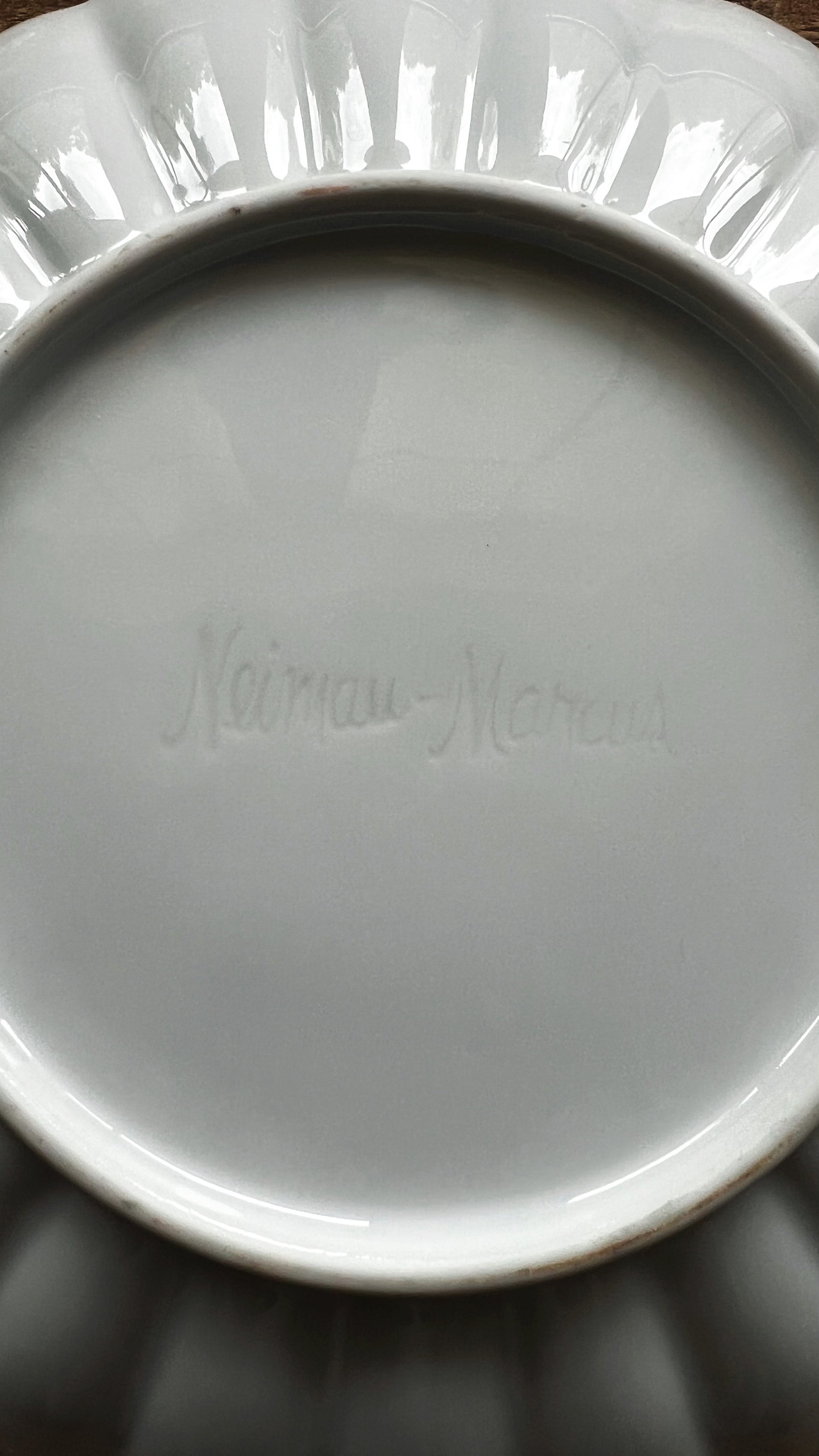 Close-up of fluted edge on white ceramic salad plate