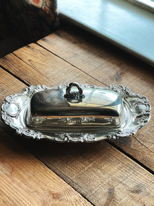 Ornate vintage silverplate butter dish with floral scroll detailing