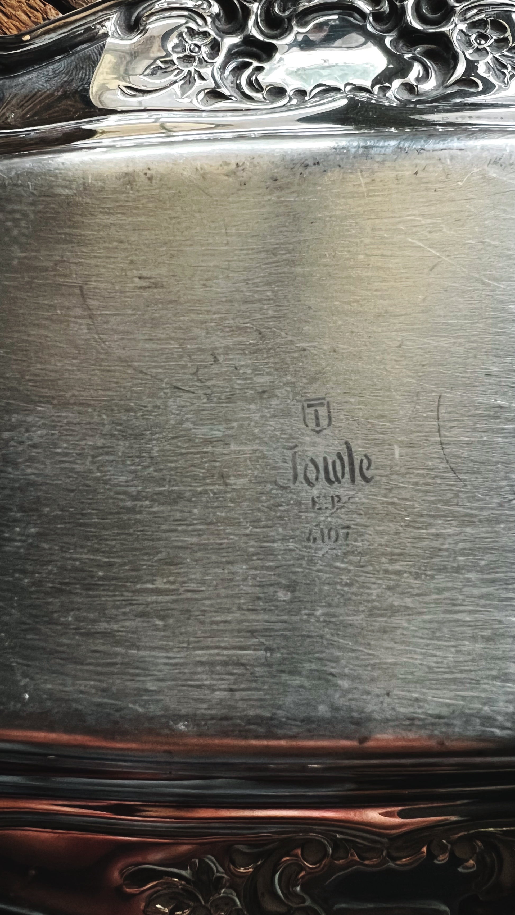 Silver butter dish with 'Towle' branding on a dark background