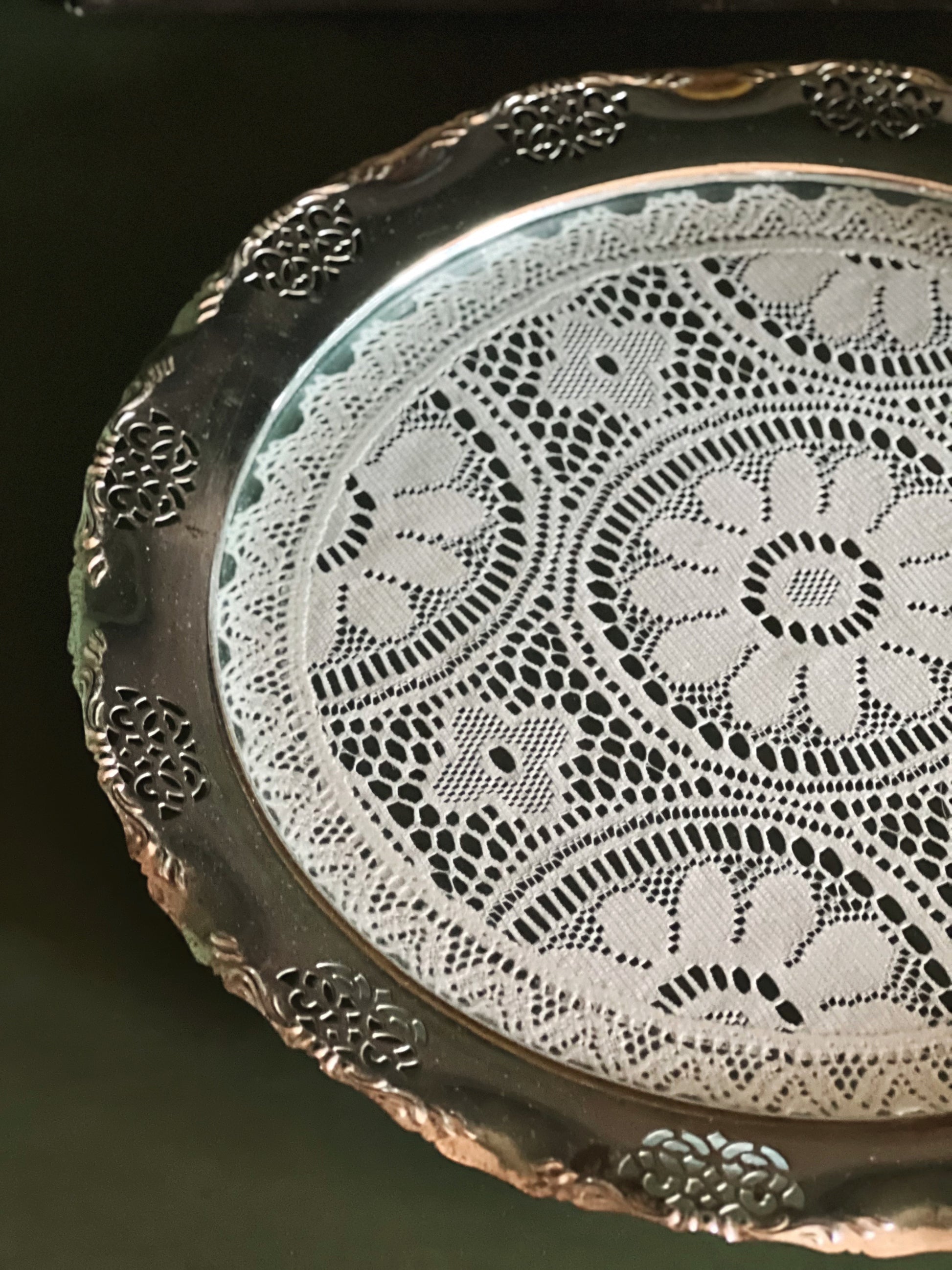 Close up of lace center detail on vintage silverplate tray