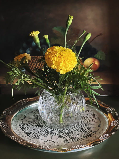 Decorative vintage silver tray styled with crystal vase and flowers